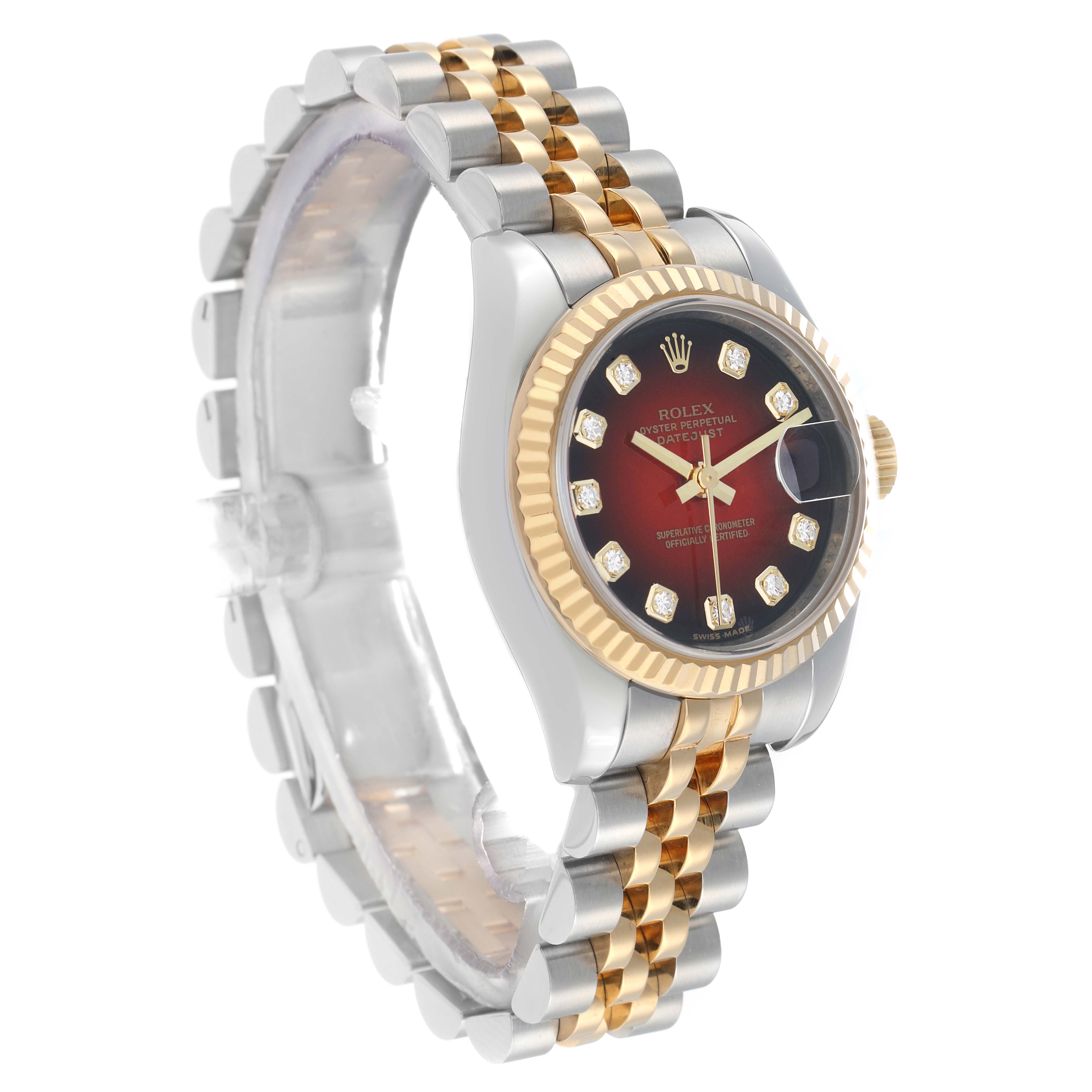 The image shows a Rolex Datejust 179173 Women
s Steel and Gold (two tone) Red Dial watch at an angled side view, highlighting its dial, bezel, and bracelet.