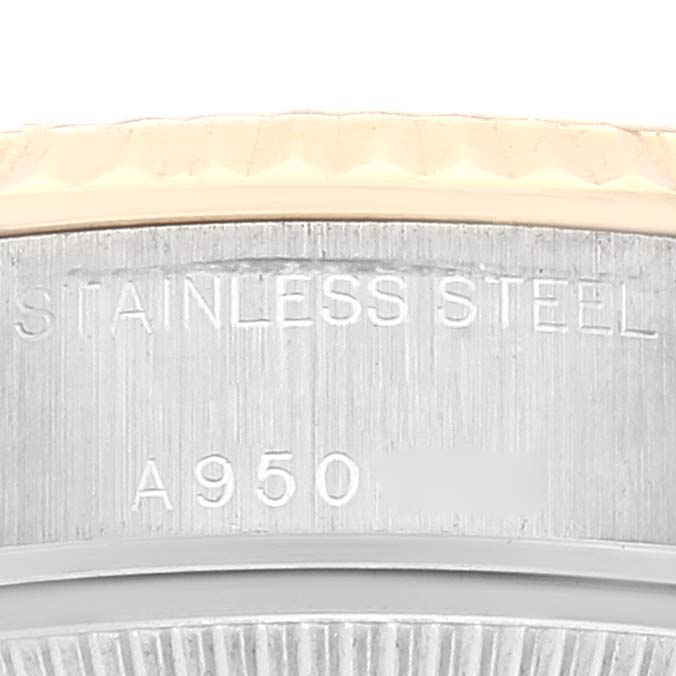 This close-up image shows the side engraving of a Rolex Datejust 79173 Women's Steel and Gold (two tone) Silver Dial 79173 Women's Steel and Gold (two tone) Silver Dial model, highlighting "STAINLESS STEEL" and a serial number.