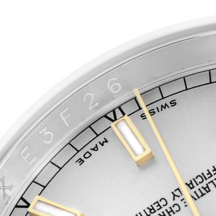 The image shows the partial dial and rehaut of a Rolex Datejust 116233 Men
s Steel and Gold (two tone) Silver Dial, highlighting the hour markers and text details.