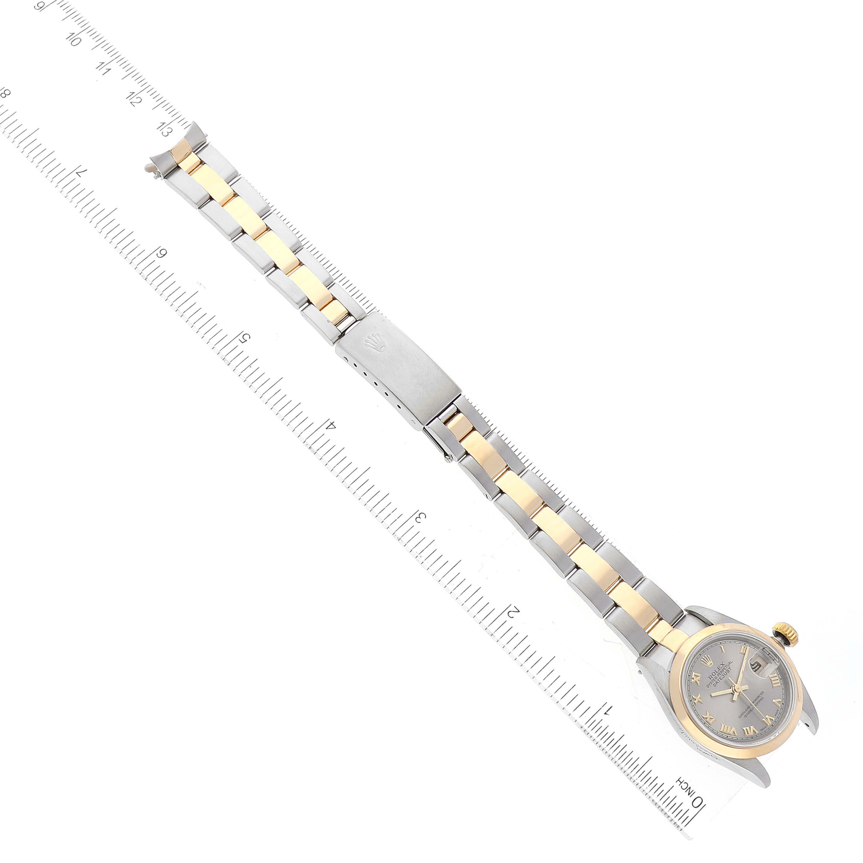 The Rolex Datejust 69163 Women's Steel and Gold (two tone) Grey Dial 69163 Women's Steel and Gold (two tone) Grey Dial watch is shown from a top-down angle, displaying its dial, bezel, and full bracelet alongside a ruler for scale.