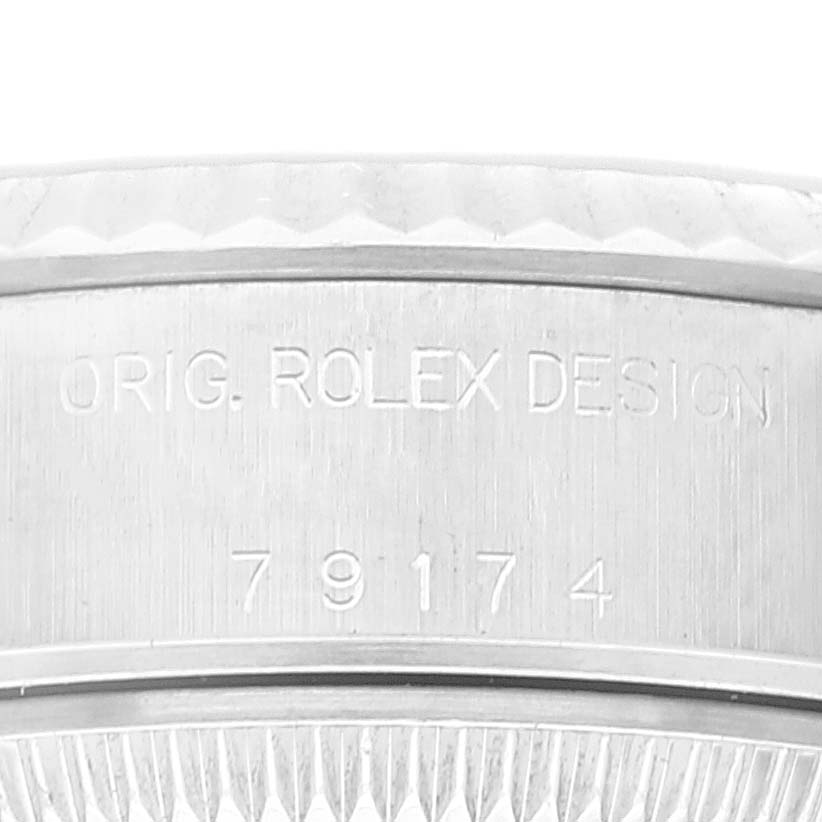 The image shows a close-up of the engraving on the side of the case of a Rolex Datejust 79174 Women's Stainless Steel Orange Dial 79174 Women's Stainless Steel Orange Dial model.
