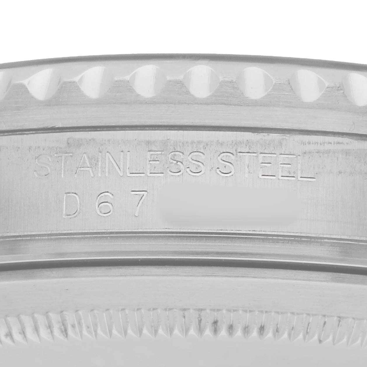 The image shows an angled close-up of the side of a Rolex GMT-Master 16710 Men
s Stainless Steel Black Dial, highlighting the stainless steel material engraving.