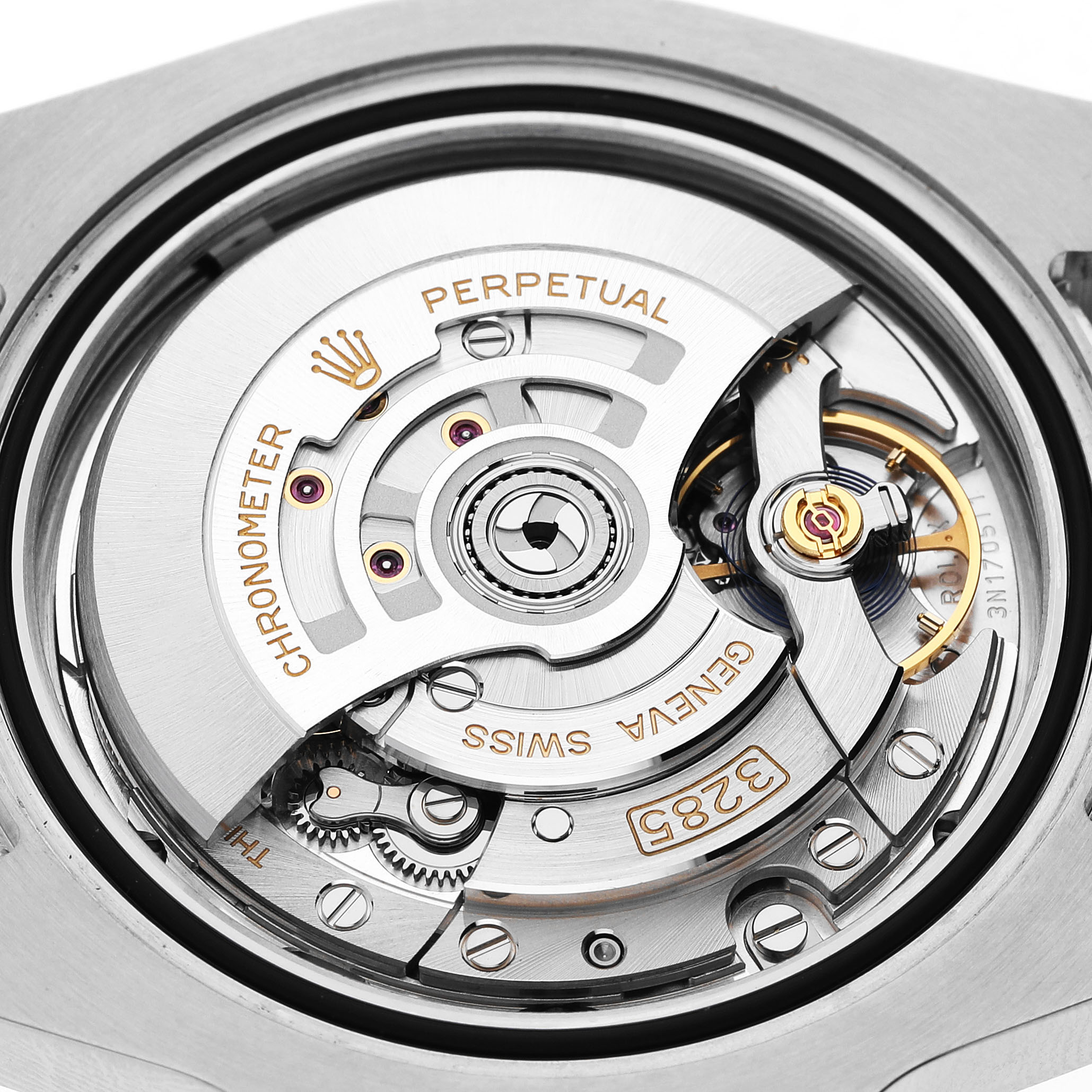 The image shows a close-up of the movement mechanism of a Rolex GMT-Master 126711 Men's Steel and Gold (two tone) Black Dial, highlighting the rotor and gears.