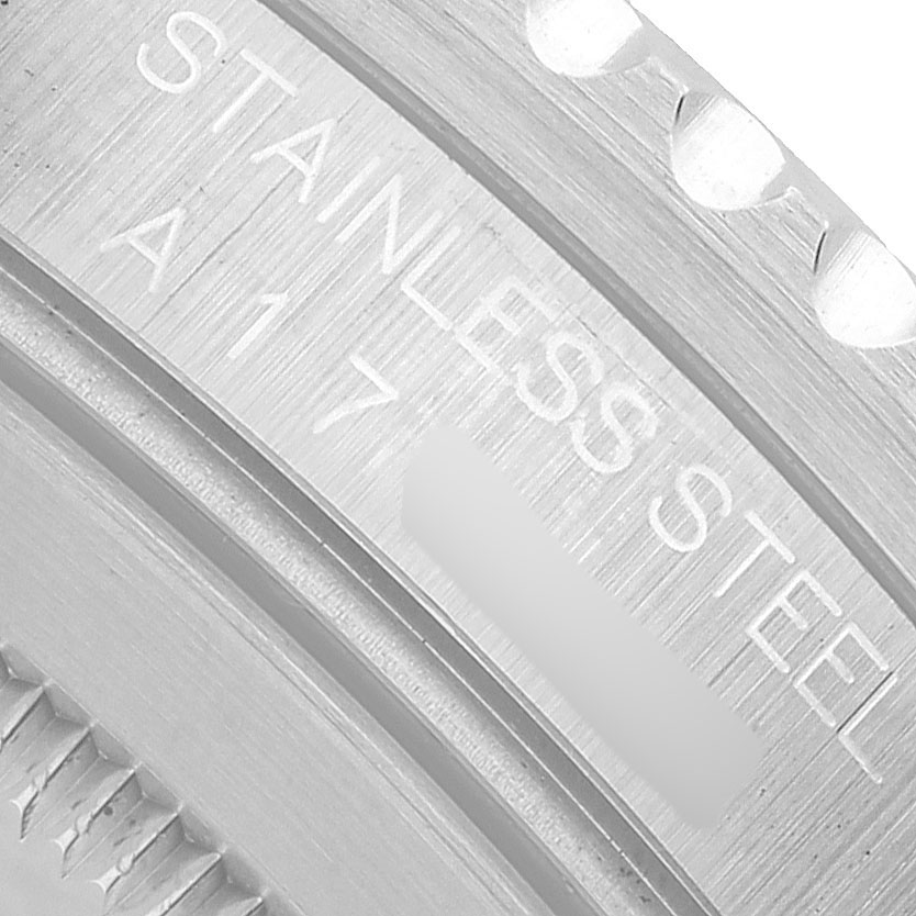 The image shows a close-up of the Rolex GMT-Master 16700 Men's Stainless Steel Black Dial watch case, highlighting the stainless steel text.