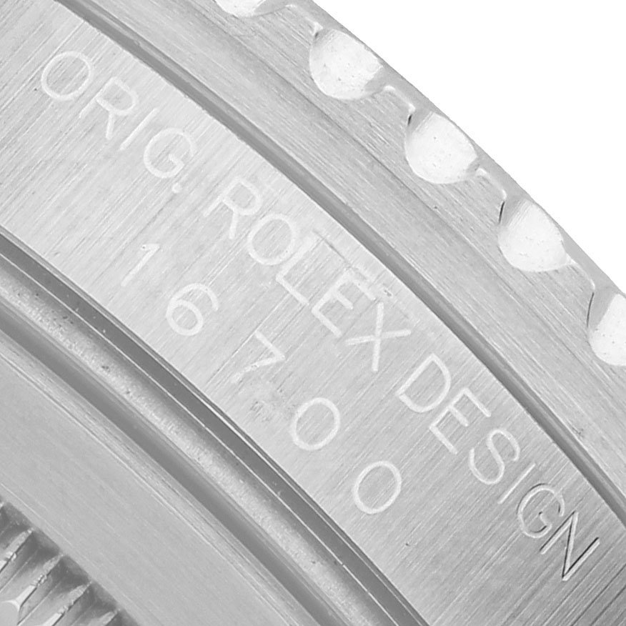 The image shows a close-up of the case side engraving on a Rolex GMT-Master 16700 Men's Stainless Steel Black Dial, highlighting the model number 16700.