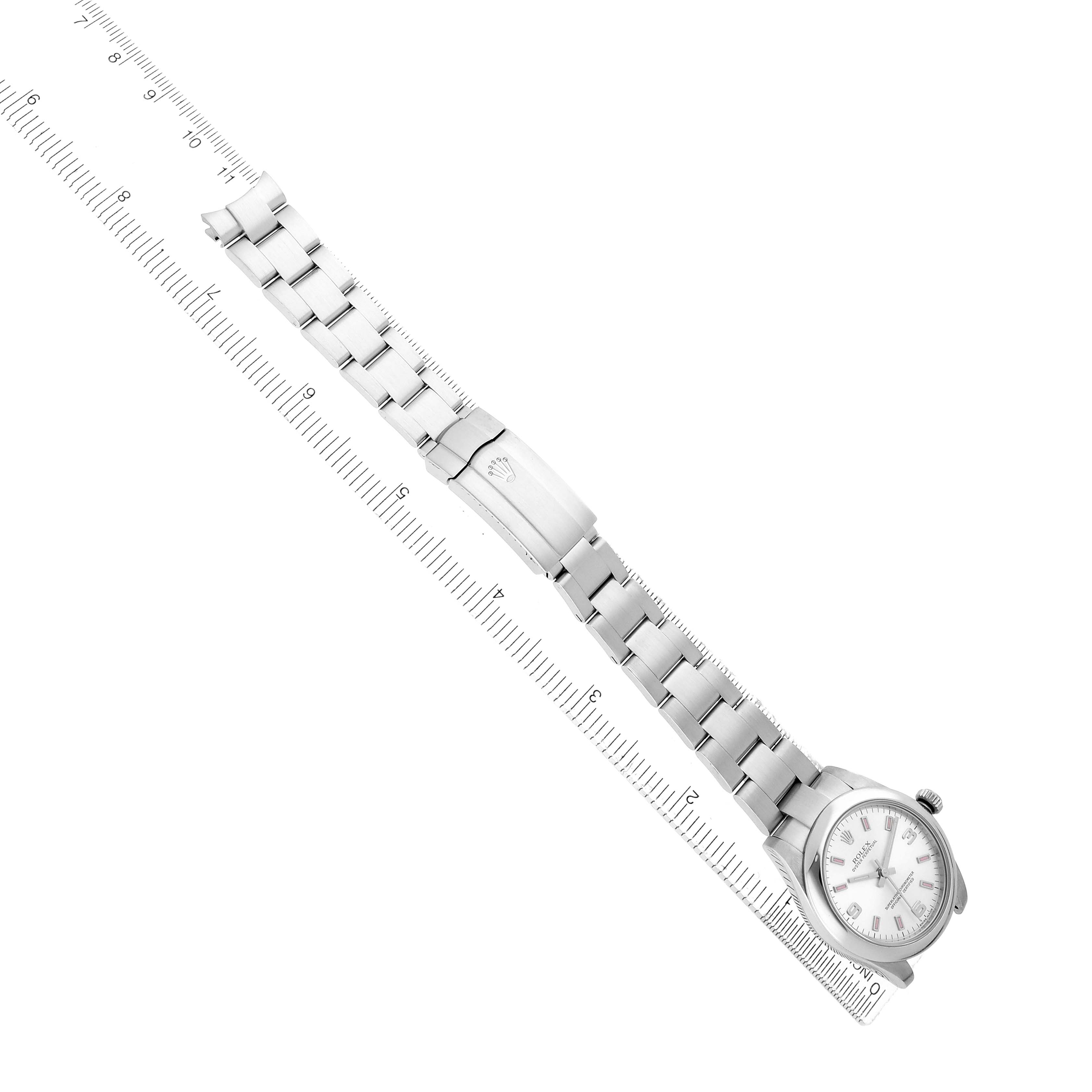 The Rolex Mid-Size 177200 Women
s Stainless Steel Silver Dial watch is shown diagonally, featuring the full bracelet and clasp beside a ruler for scale.