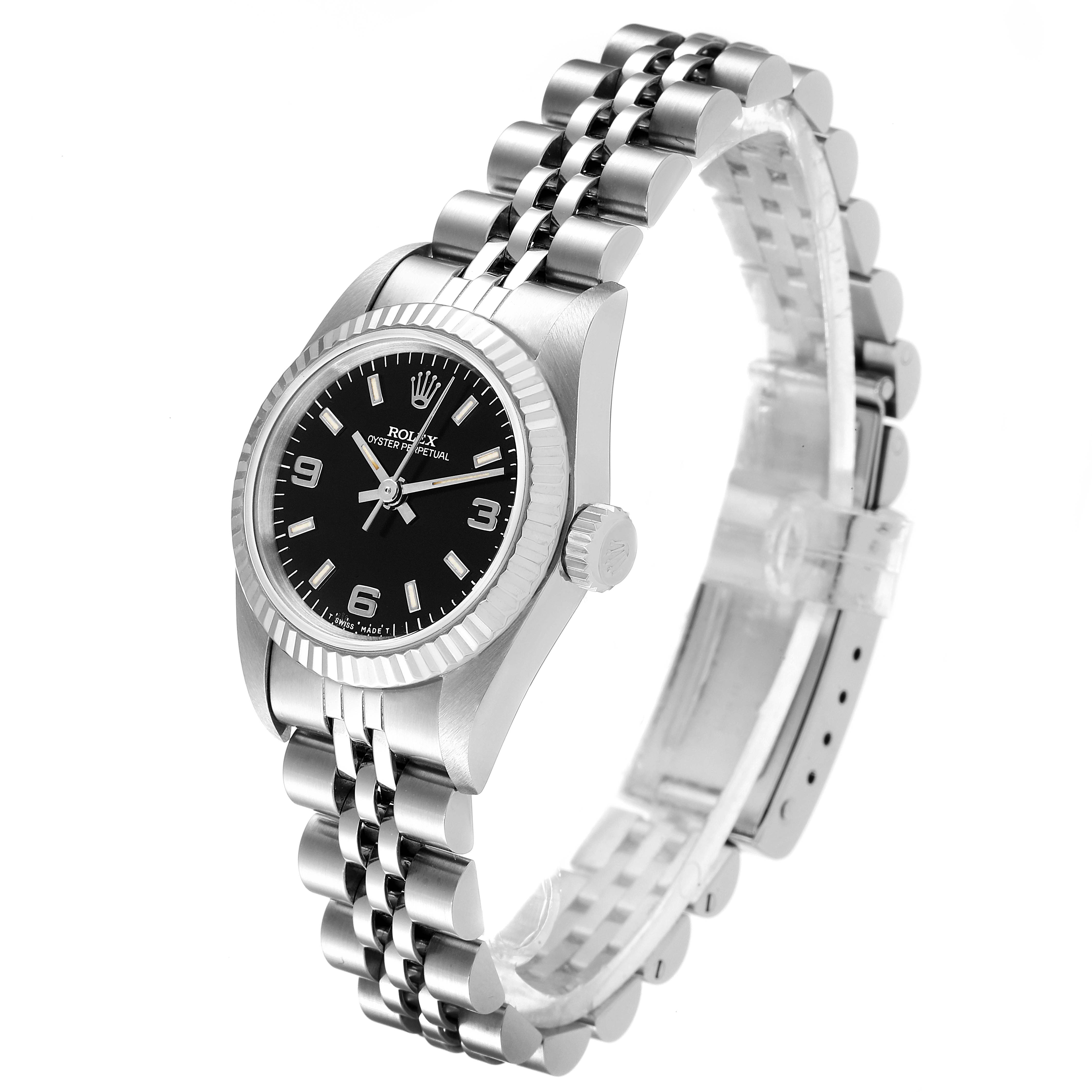 This image shows a side angle of a Rolex Oyster Perpetual 67194 Women's Stainless Steel Black Dial 67194 Women's Stainless Steel Black Dial watch highlighting the bracelet, bezel, dial, crown, and lugs.