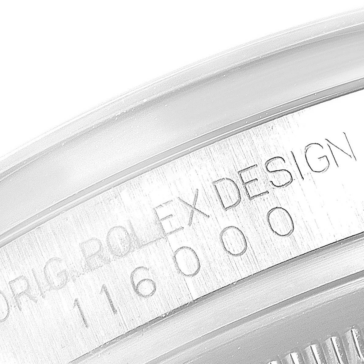 This close-up angle shows the engraving on the inner bezel of the Rolex Oyster Perpetual 116000 Men's Stainless Steel Blue Dial 116000 Men's Stainless Steel Blue Dial model.
