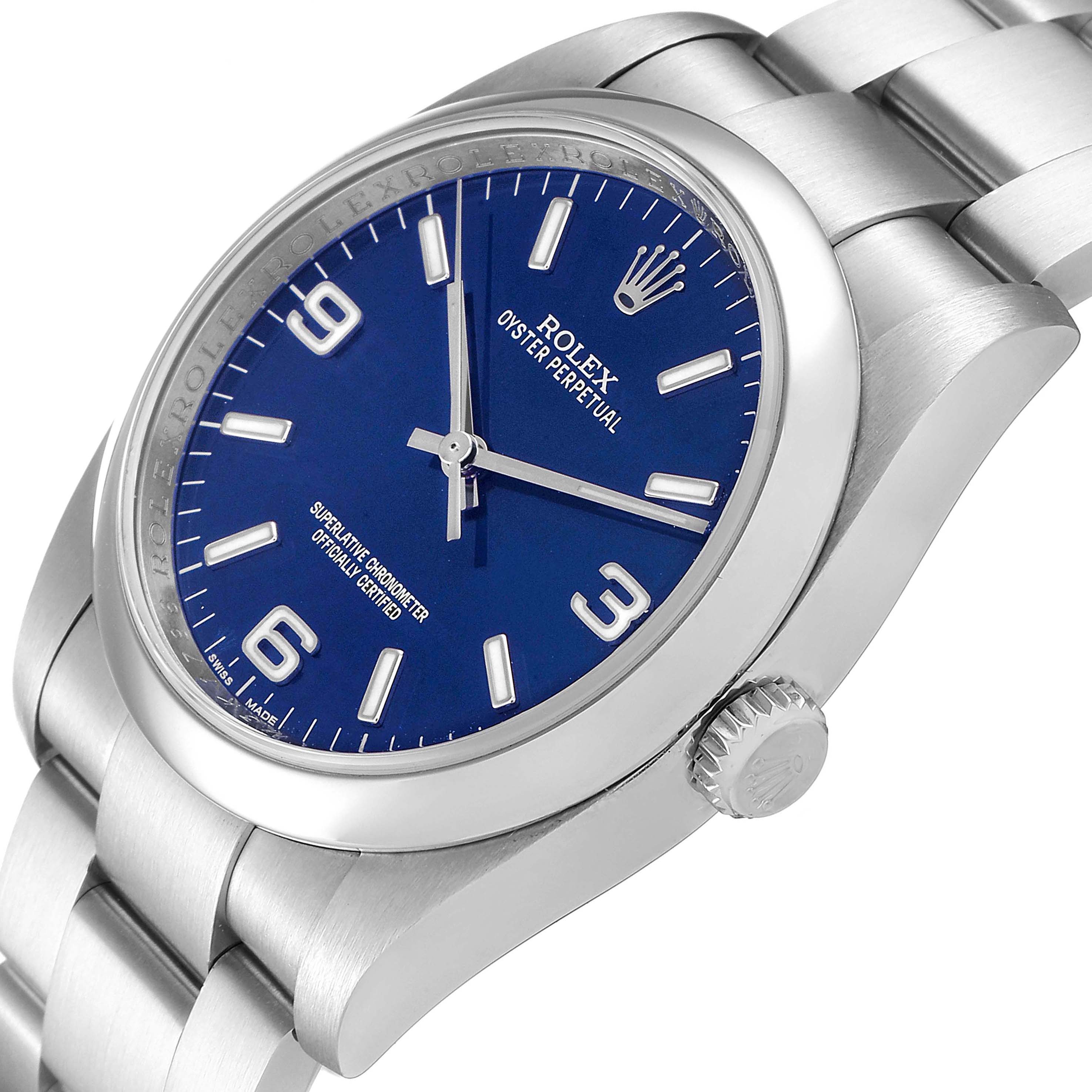 The image shows a side and slight top view of the Rolex Oyster Perpetual 116000 Men's Stainless Steel Blue Dial 116000 Men's Stainless Steel Blue Dial watch, highlighting the dial, case, and part of the bracelet.