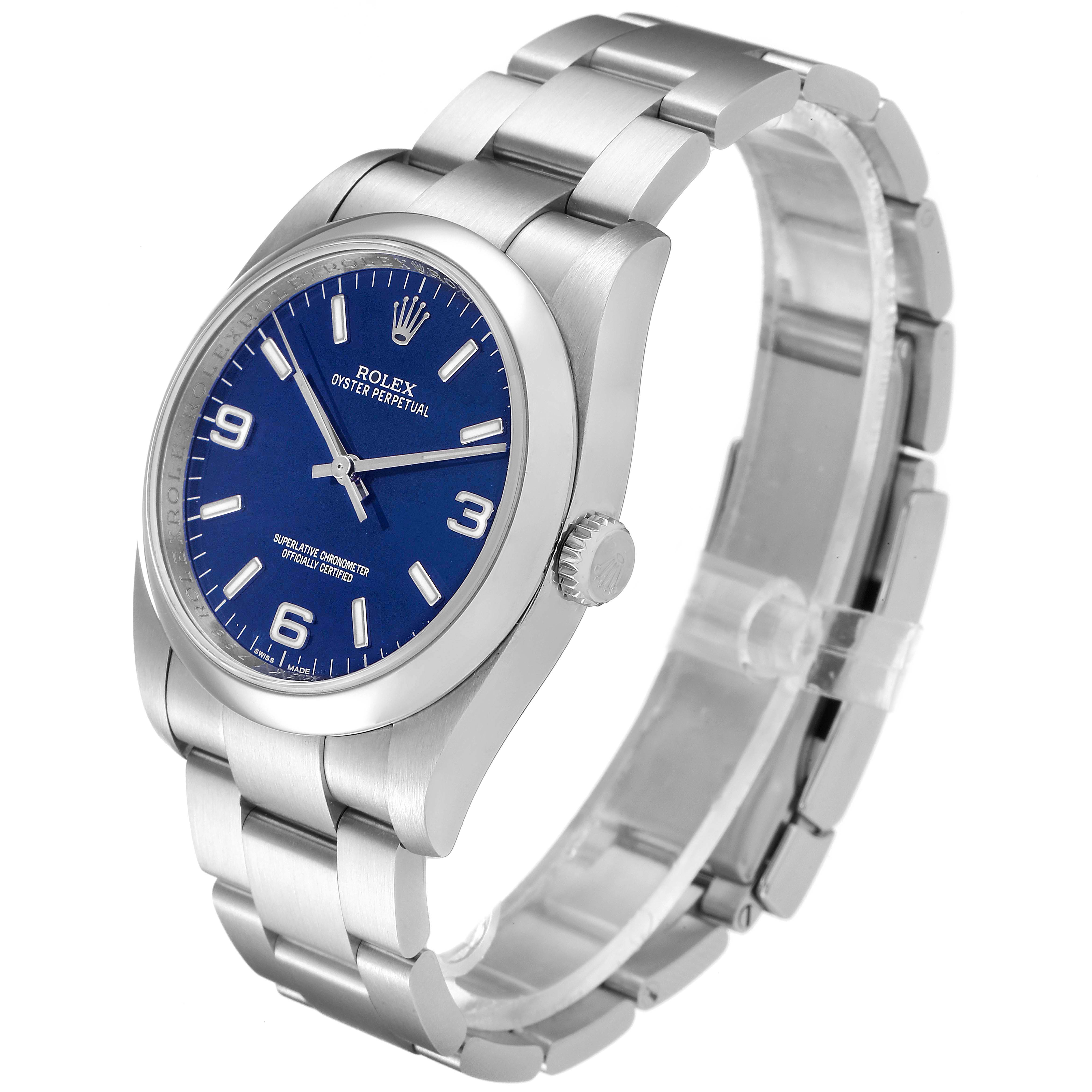 The image shows a side angle of a Rolex Oyster Perpetual 116000 Men's Stainless Steel Blue Dial 116000 Men's Stainless Steel Blue Dial watch, featuring a blue dial and silver bracelet.