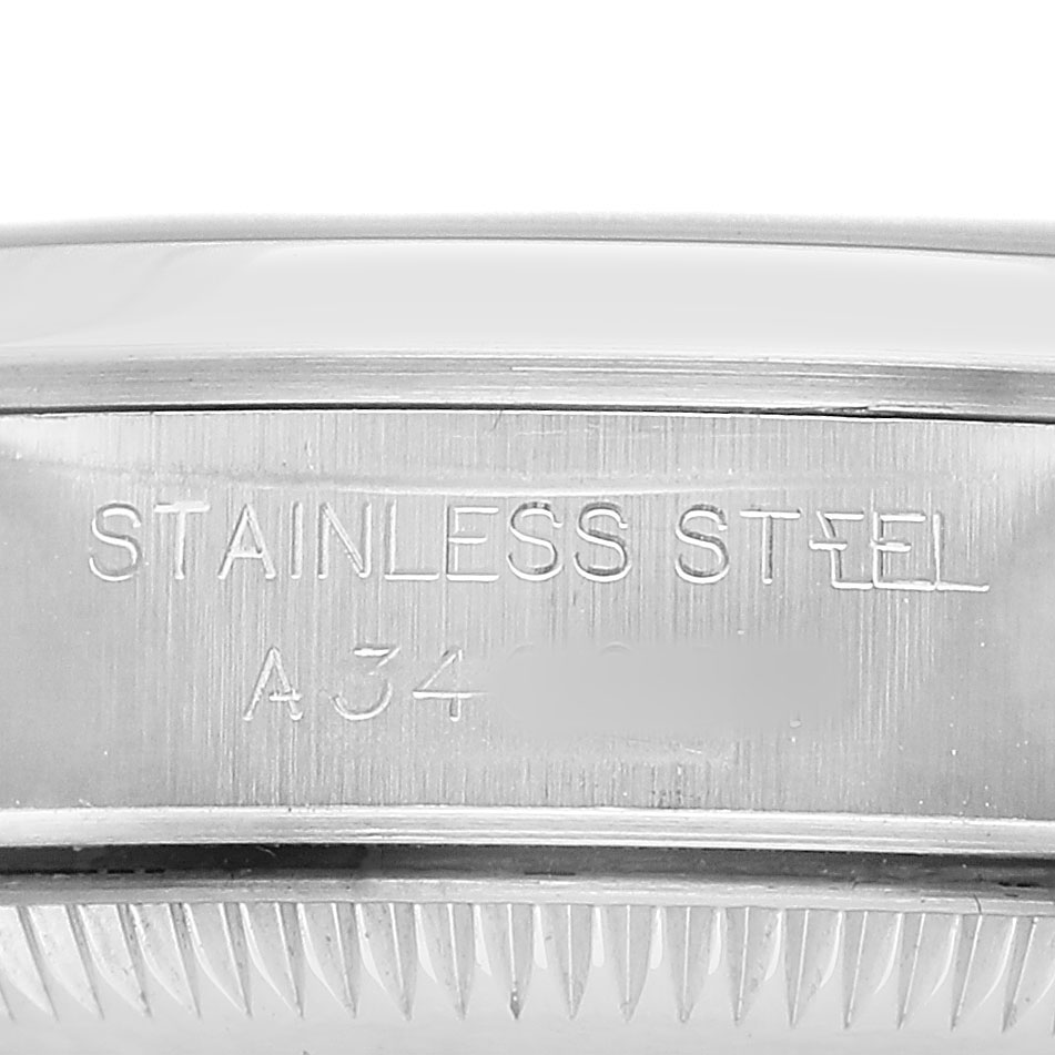 The image shows a close-up of the case back rim of a Rolex Oyster Perpetual 76080 Women's Stainless Steel Black Dial, highlighting its stainless steel engraving.