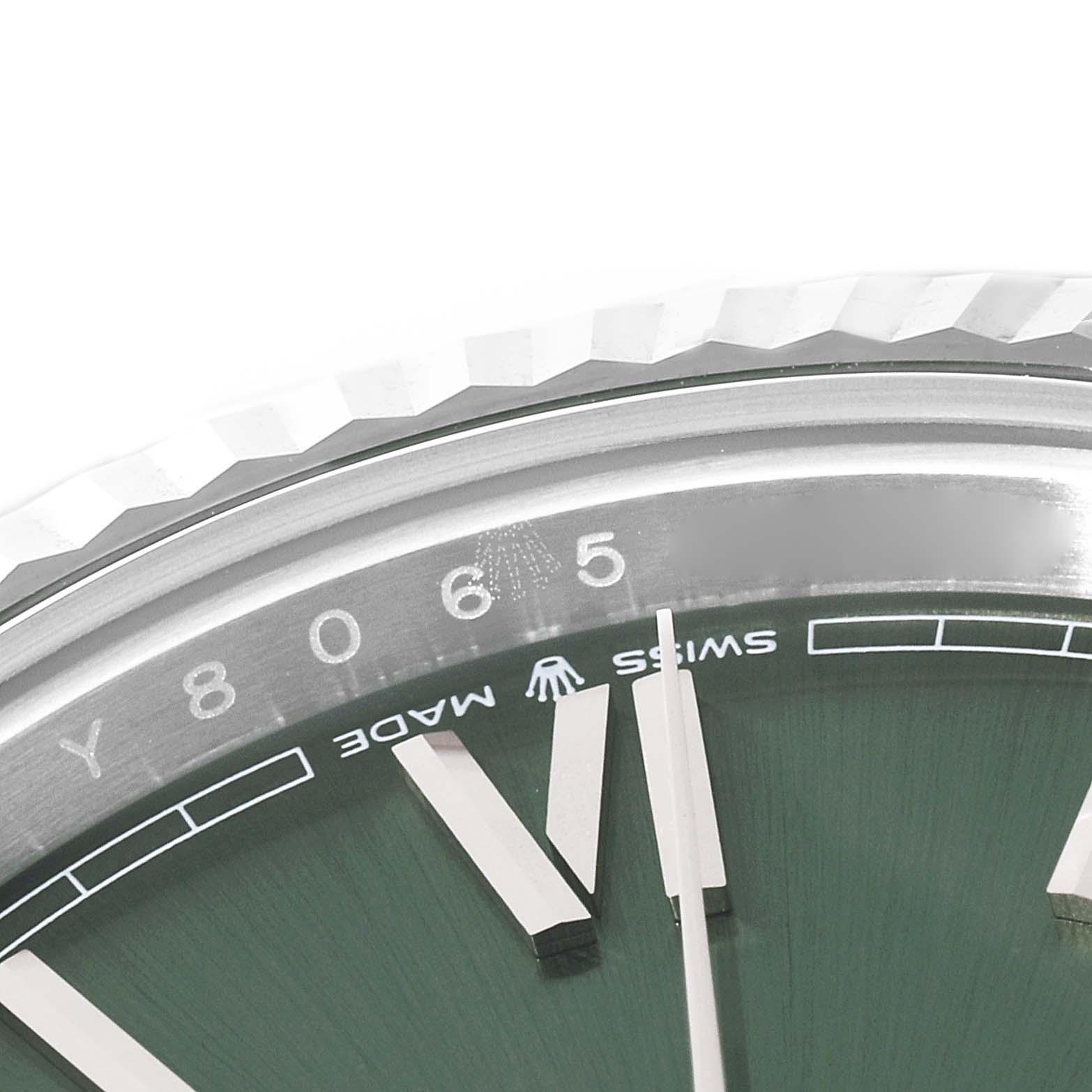 This close-up image shows the dial and the edge of the bezel of a Rolex President 228239 Men's White Gold Green Dial 228239 Men's White Gold Green Dial watch.