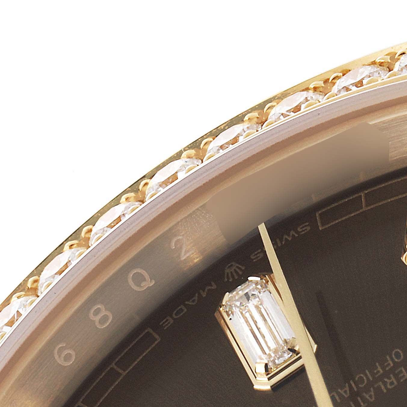 A close-up of the Rolex President 128348 Men
s Yellow Gold Grey Dial 128348 Men
s Yellow Gold Grey Dial watch shows part of the bezel encrusted with diamonds and a portion of the watch face.