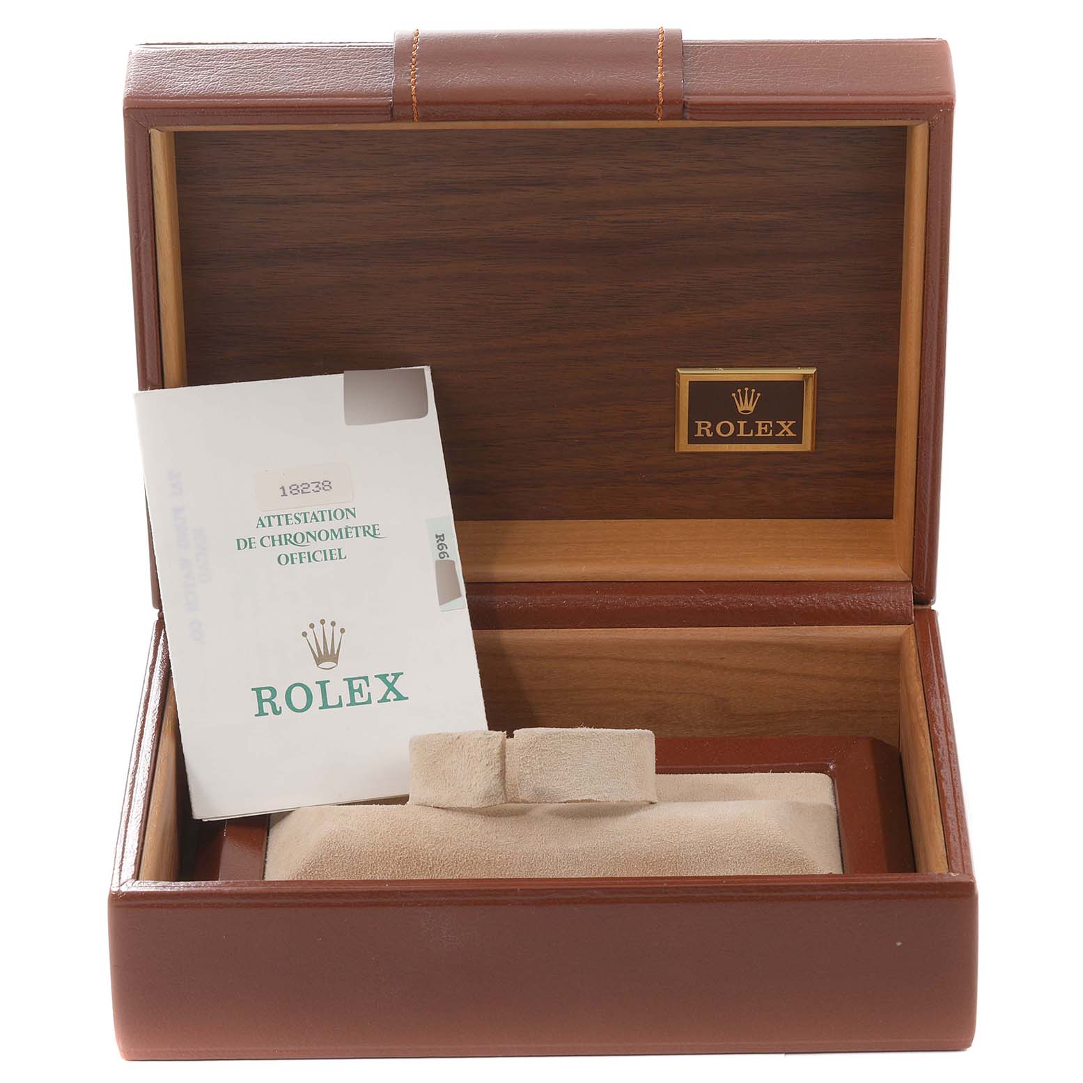 The image shows an open Rolex box for the President model, featuring a booklet and a beige watch cushion.