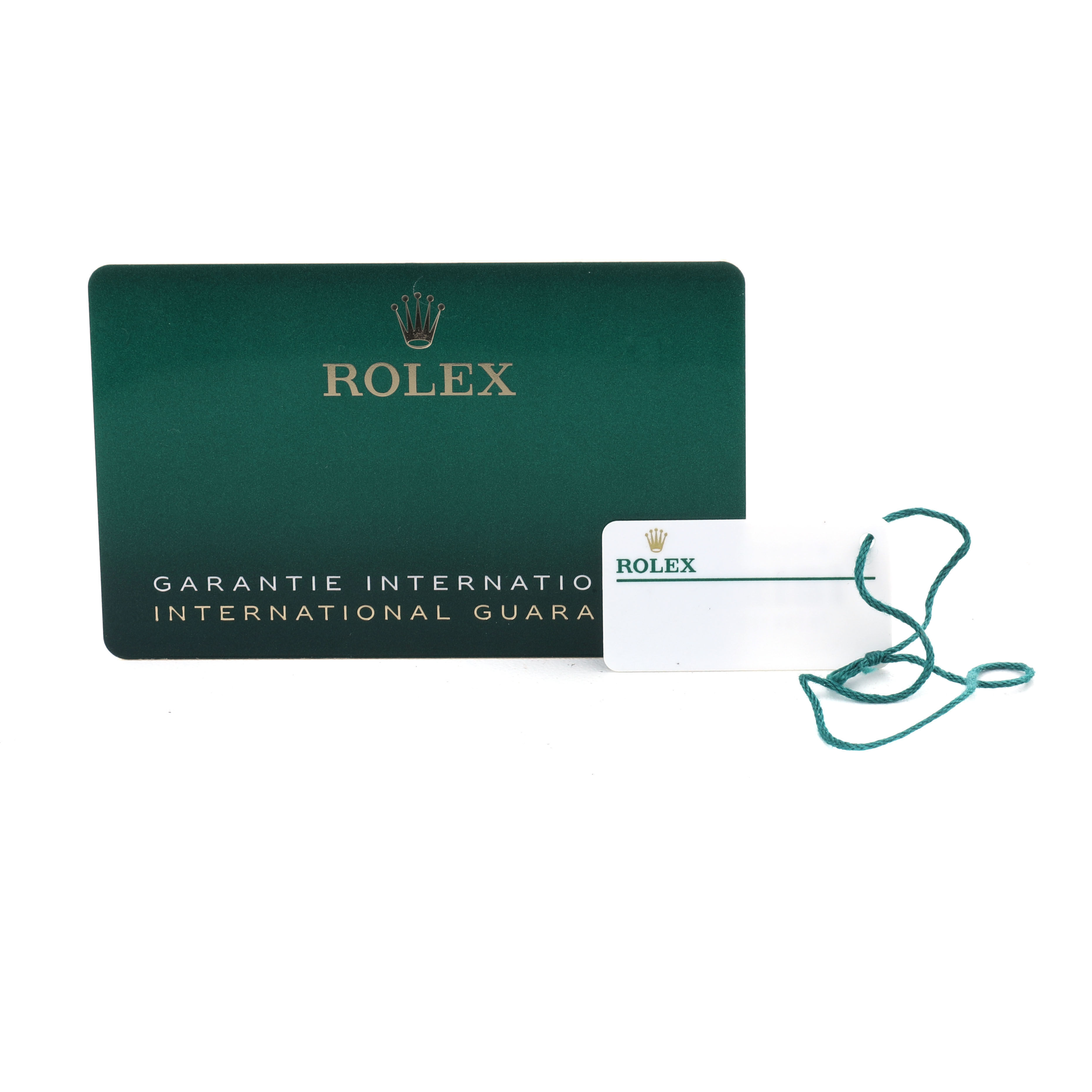 The image shows a Rolex Sea-Dweller 126600 Men's Stainless Steel Black Dial warranty card beside a white tag with a green string.