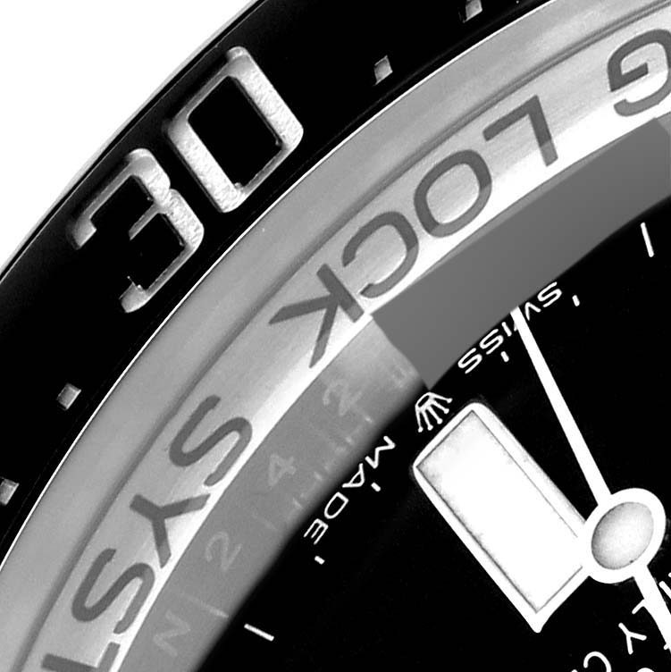 This close-up image of the Rolex Sea-Dweller 126660 Men's Stainless Steel Blue Dial 126660 Men's Stainless Steel Blue Dial watch shows parts of the bezel and dial.