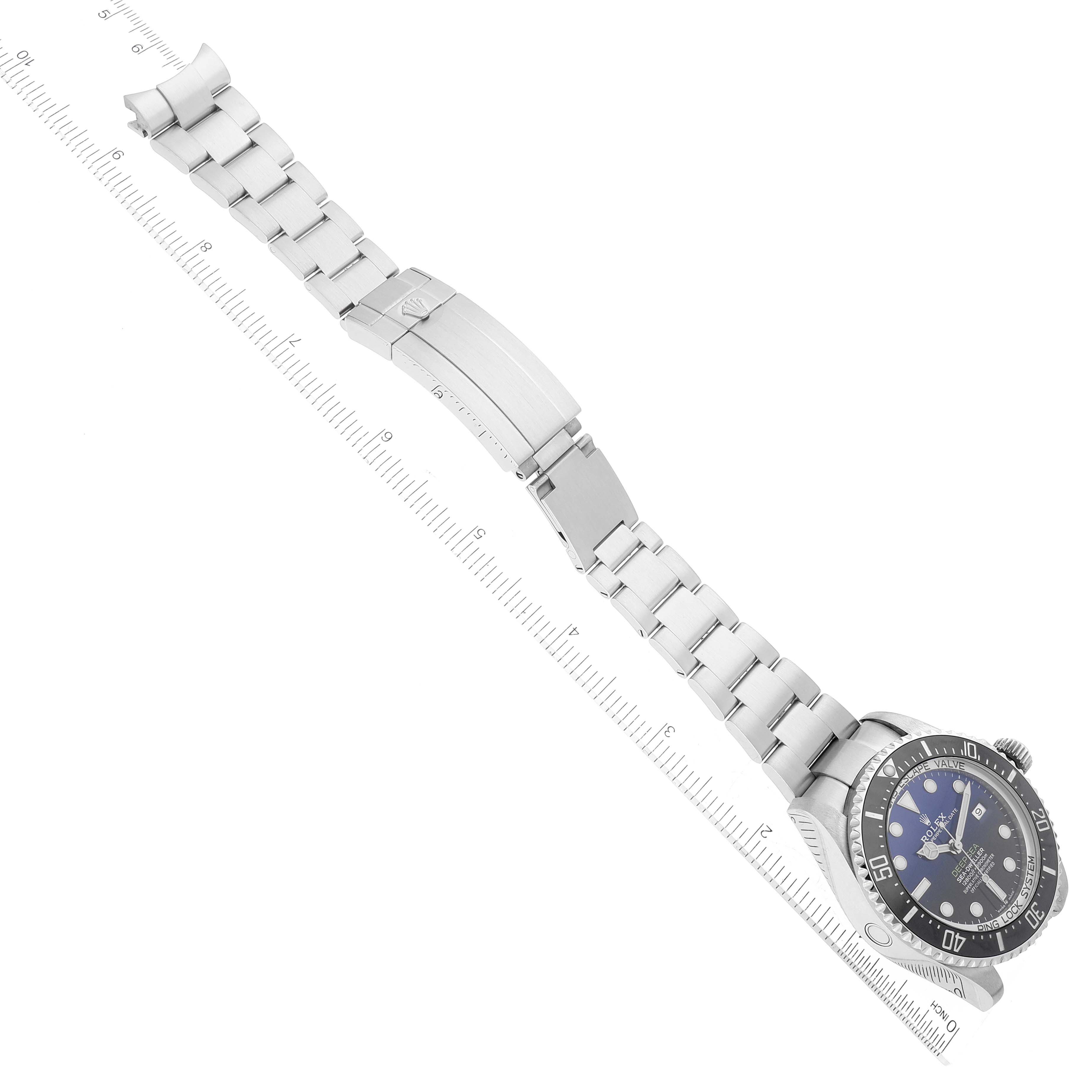 The image shows the Rolex Sea-Dweller 126660 Men's Stainless Steel Blue Dial 126660 Men's Stainless Steel Blue Dial watch laid flat with an open bracelet and ruler for reference.