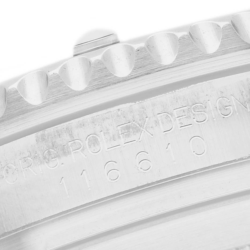 The image shows a close-up of the case side of a Rolex Submariner 116610 Men
s Stainless Steel Black Dial, highlighting the engraved model number and bezel edge.