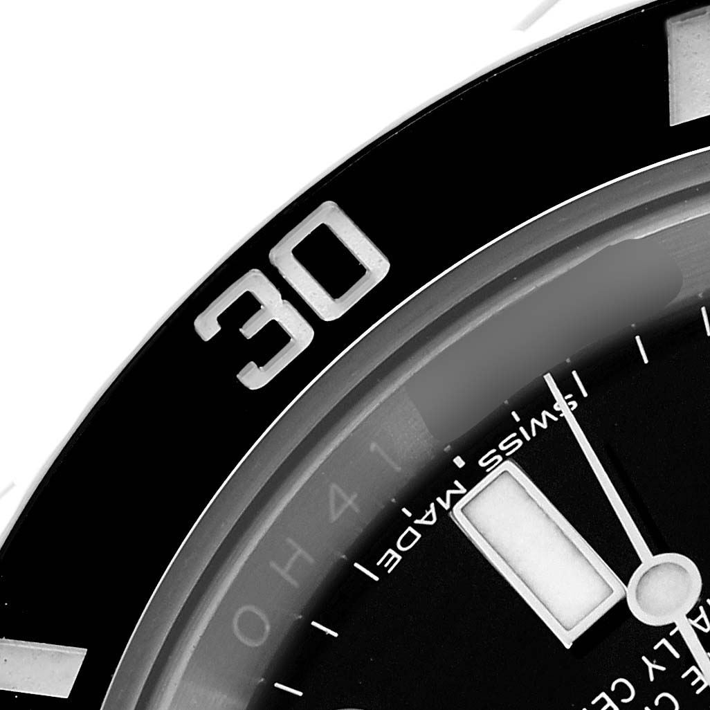 The image shows a close-up of the bezel and dial of a Rolex Submariner 116610 Men
s Stainless Steel Black Dial, highlighting the "30" marking and part of the watch face.