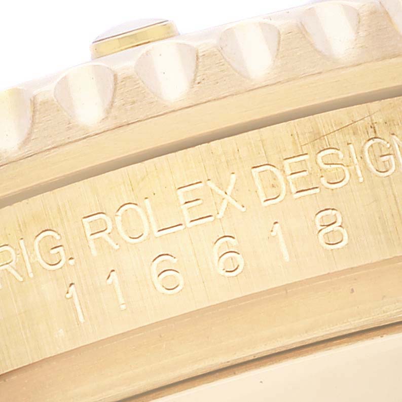 This image shows a close-up of the engraved side of a Rolex Submariner 116618 Men's Yellow Gold Blue Dial 116618 Men's Yellow Gold Blue Dial watch, specifically the model and branding details.