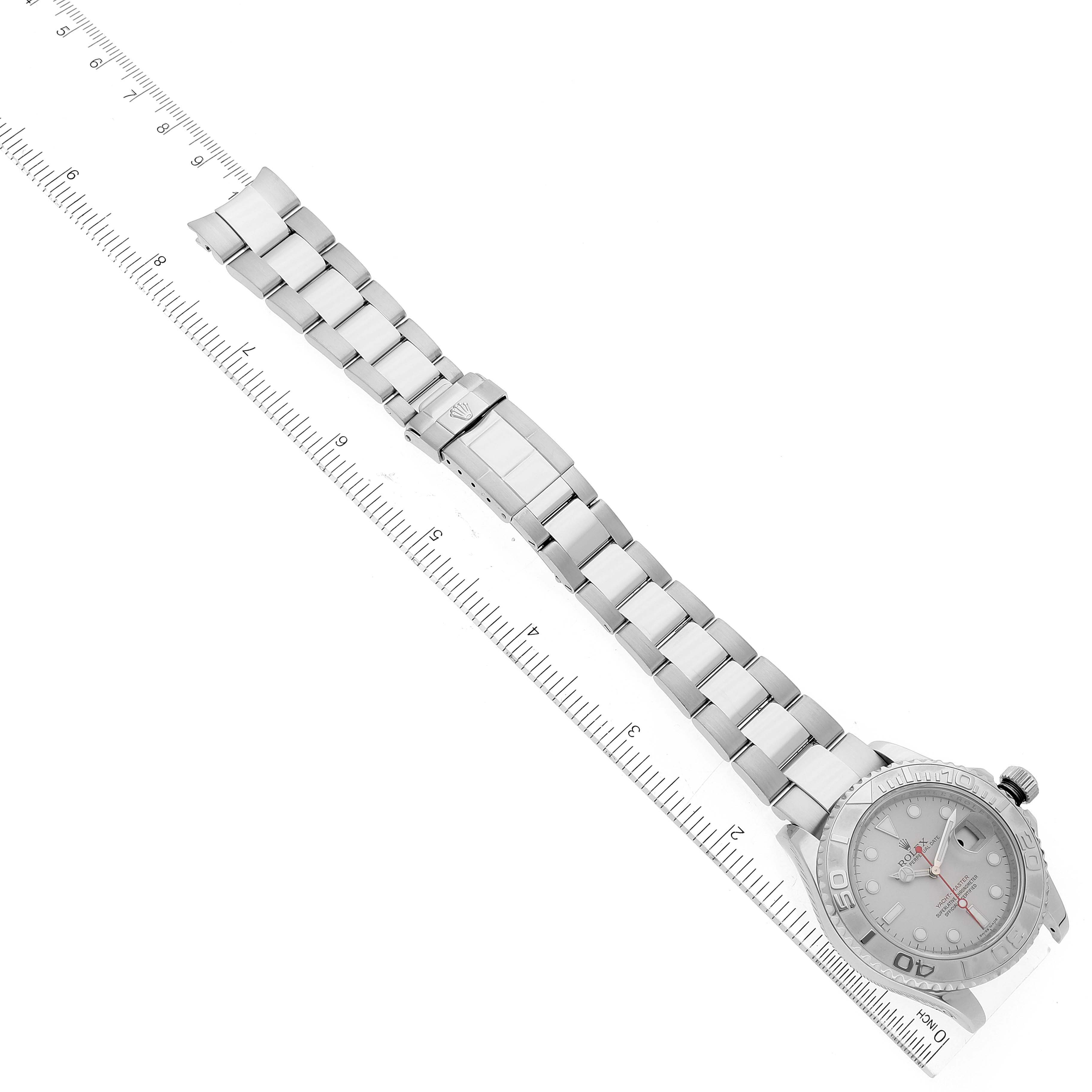 The Rolex Yacht-Master 16622 Men
s Stainless Steel Silver Dial 16622 Men
s Stainless Steel Silver Dial watch is shown at an angle with the full bracelet, clasp, and case visible along a ruler for scale.