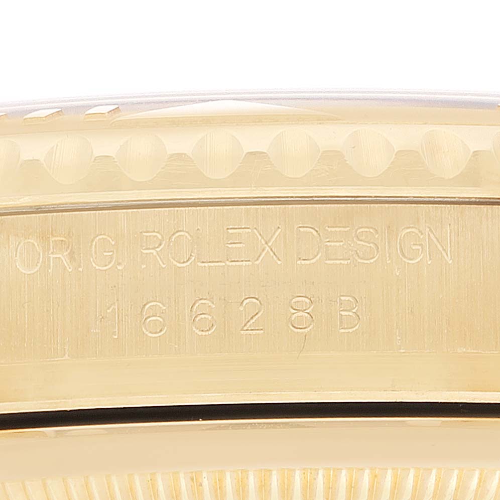 This image shows a detailed close-up of the side of the watch case, revealing the engraved text "OR. G. ROLEX DESIGN 16628 B" on the Rolex Yacht-Master 16628 Men
s Yellow Gold White Dial 16628 Men
s Yellow Gold White Dial.