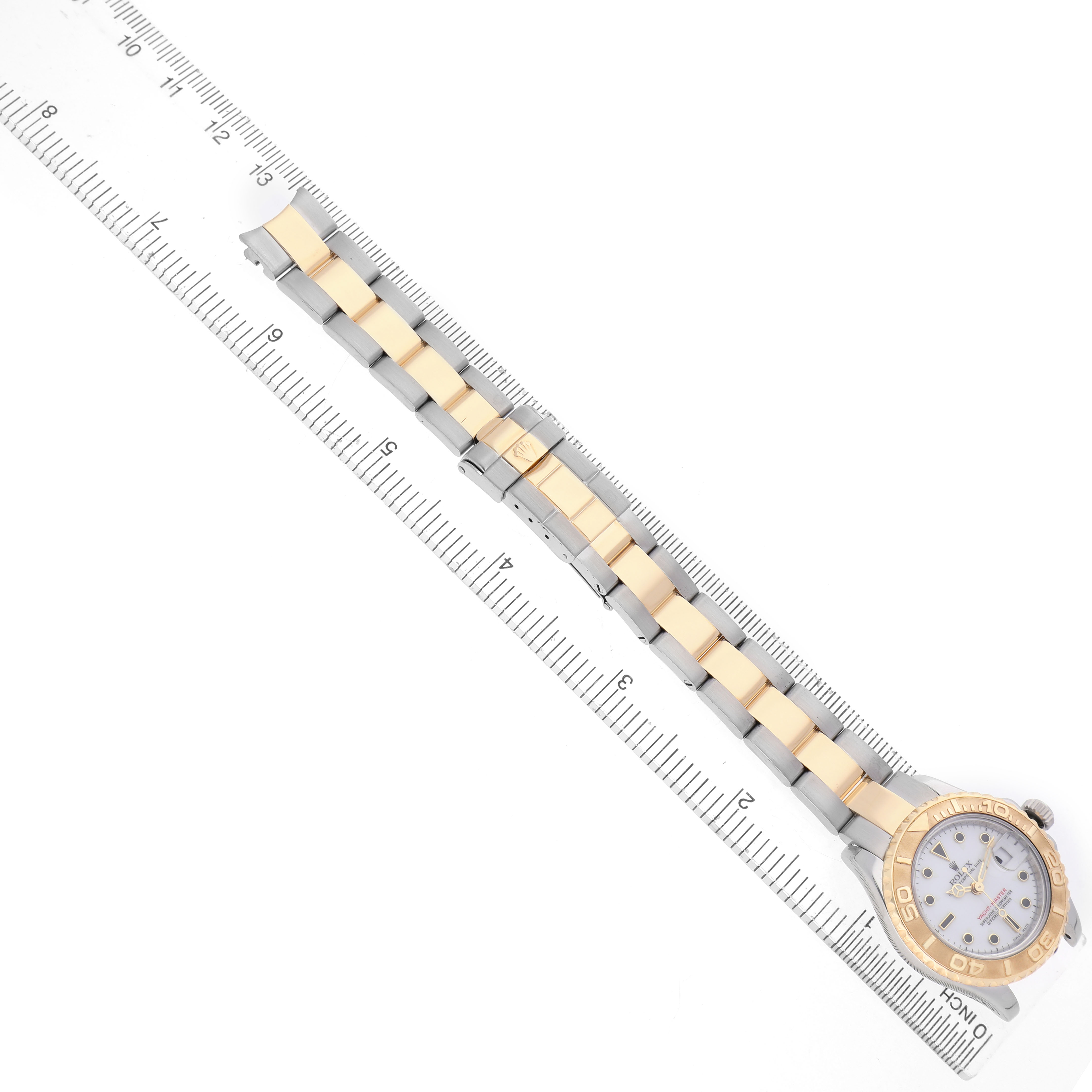 The image shows a top-down view of a Rolex Yacht-Master 169623 Women's Steel and Gold (two tone) White Dial watch, highlighting its gold and silver bracelet and bezel.
