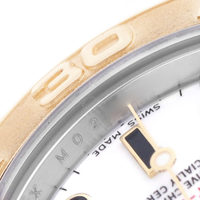 The image shows a close-up of the Rolex Yacht-Master 169623 Women's Steel and Gold (two tone) White Dial's bezel and part of the dial.
