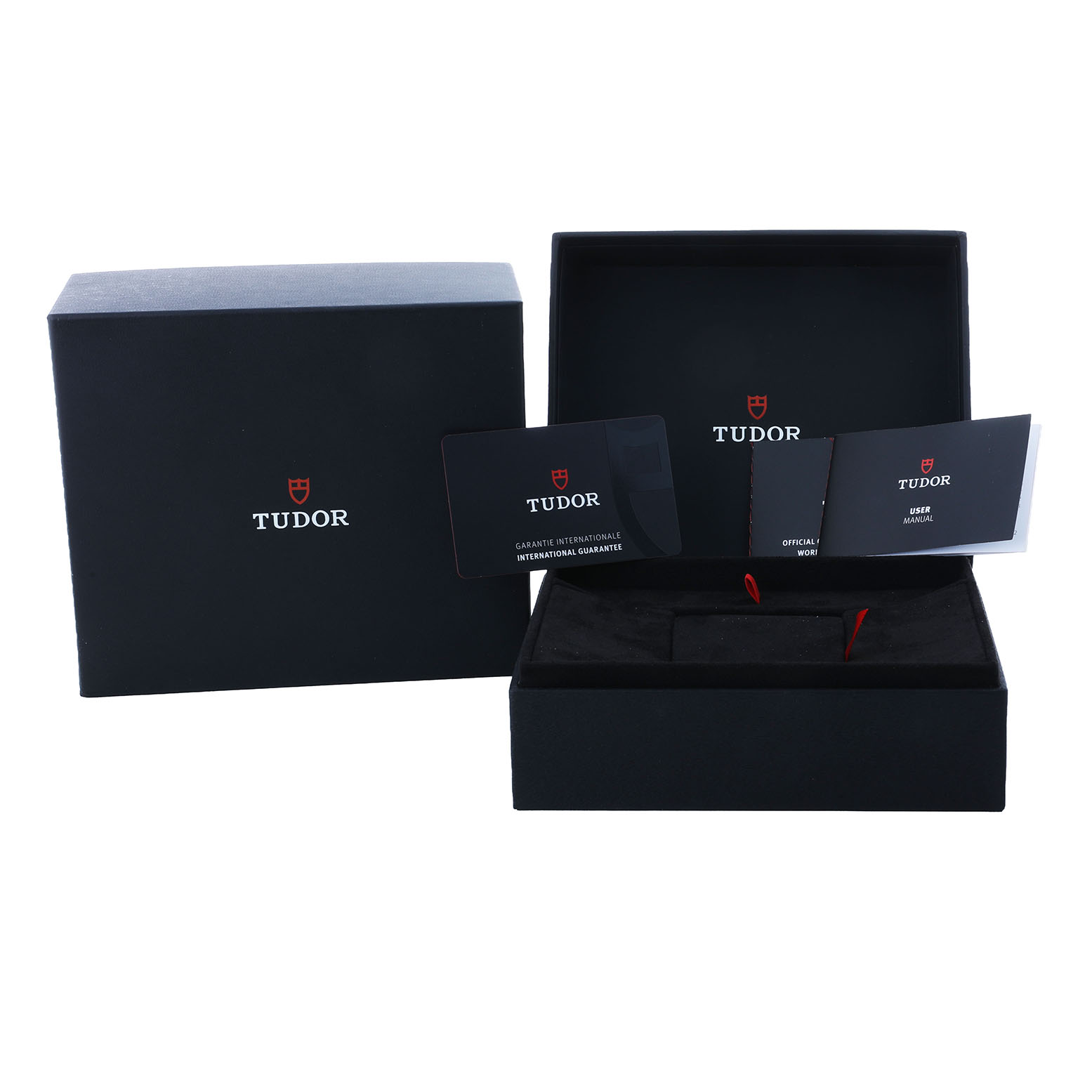 The image shows an open Tudor Heritage Ranger 79950-0001 Men's Stainless Steel Black Dial watch box with warranty and user manual cards placed inside and beside it.