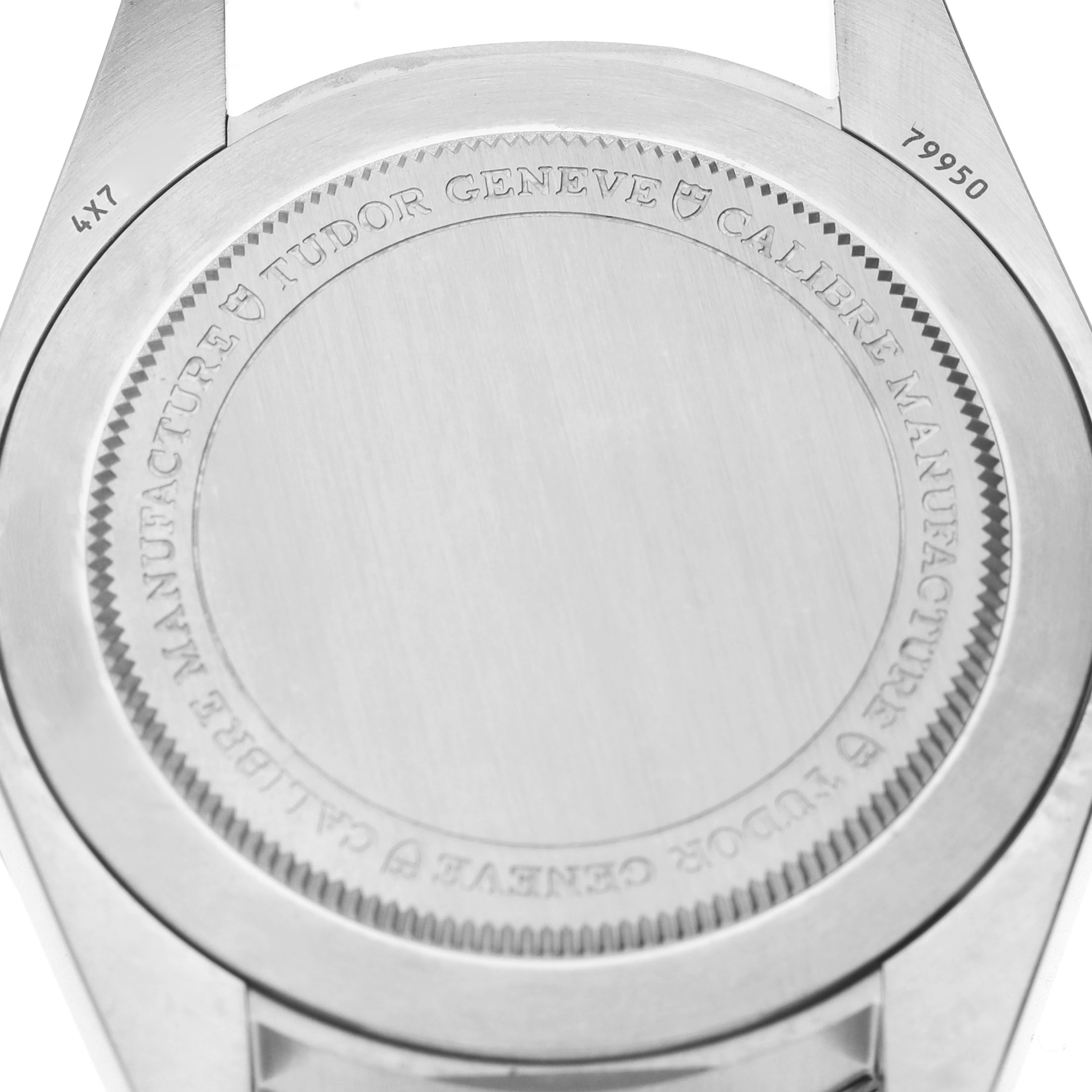 The image shows the back case of the Tudor Heritage Ranger 79950-0001 Men's Stainless Steel Black Dial watch, highlighting the engraved details.