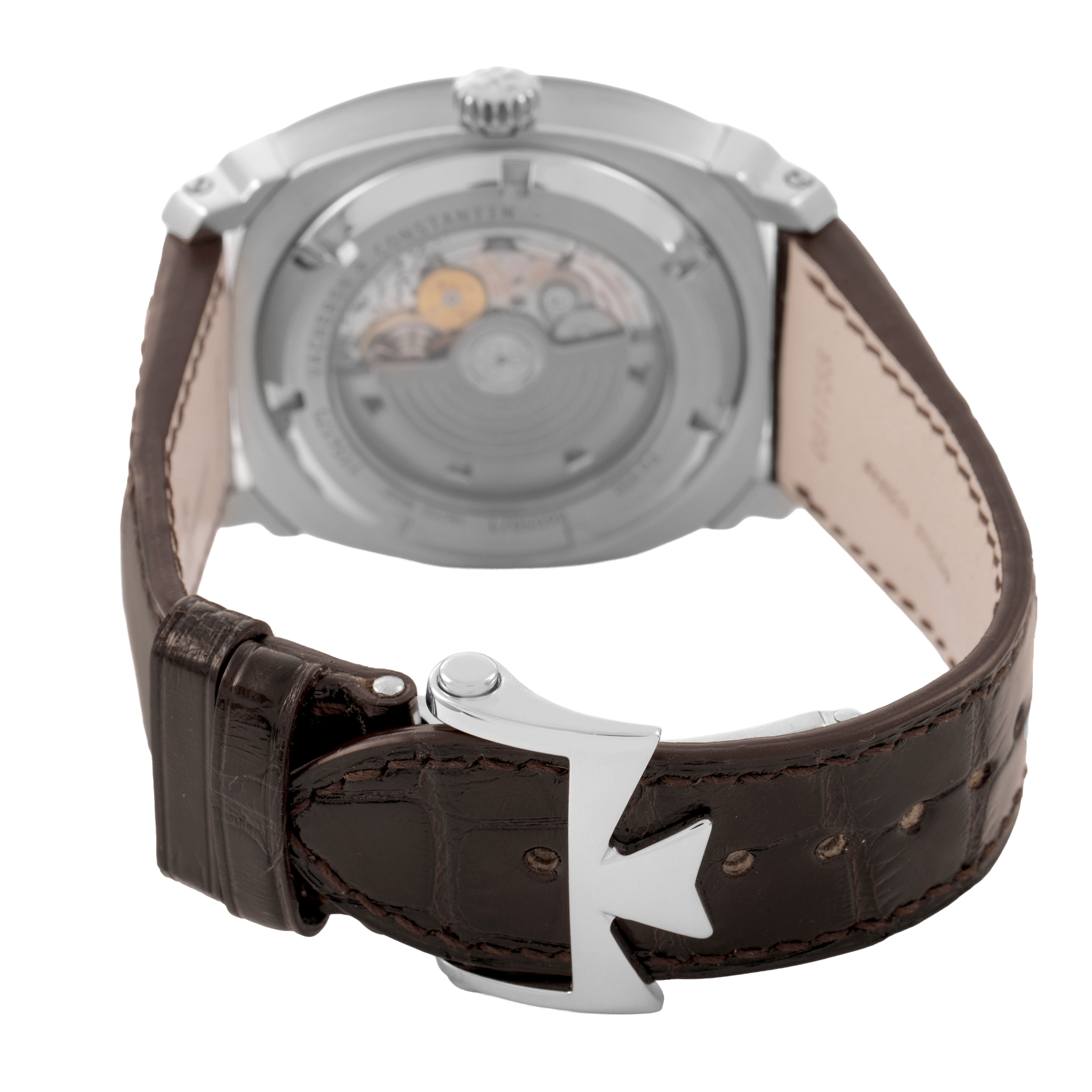 The image shows the back of a Vacheron Constantin Quai de L'Ile watch, highlighting the movement and brown strap with a clasp.