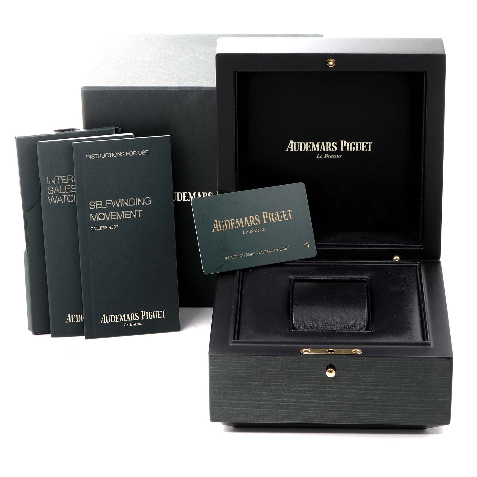 The image shows the packaging of an Audemars Piguet Royal Oak 15500ST.OO.1220ST.02 Men's Stainless Steel Grey Dial 15500ST.OO.1220ST.02 Men's Stainless Steel Grey Dial watch, including the box, manuals, and warranty card.