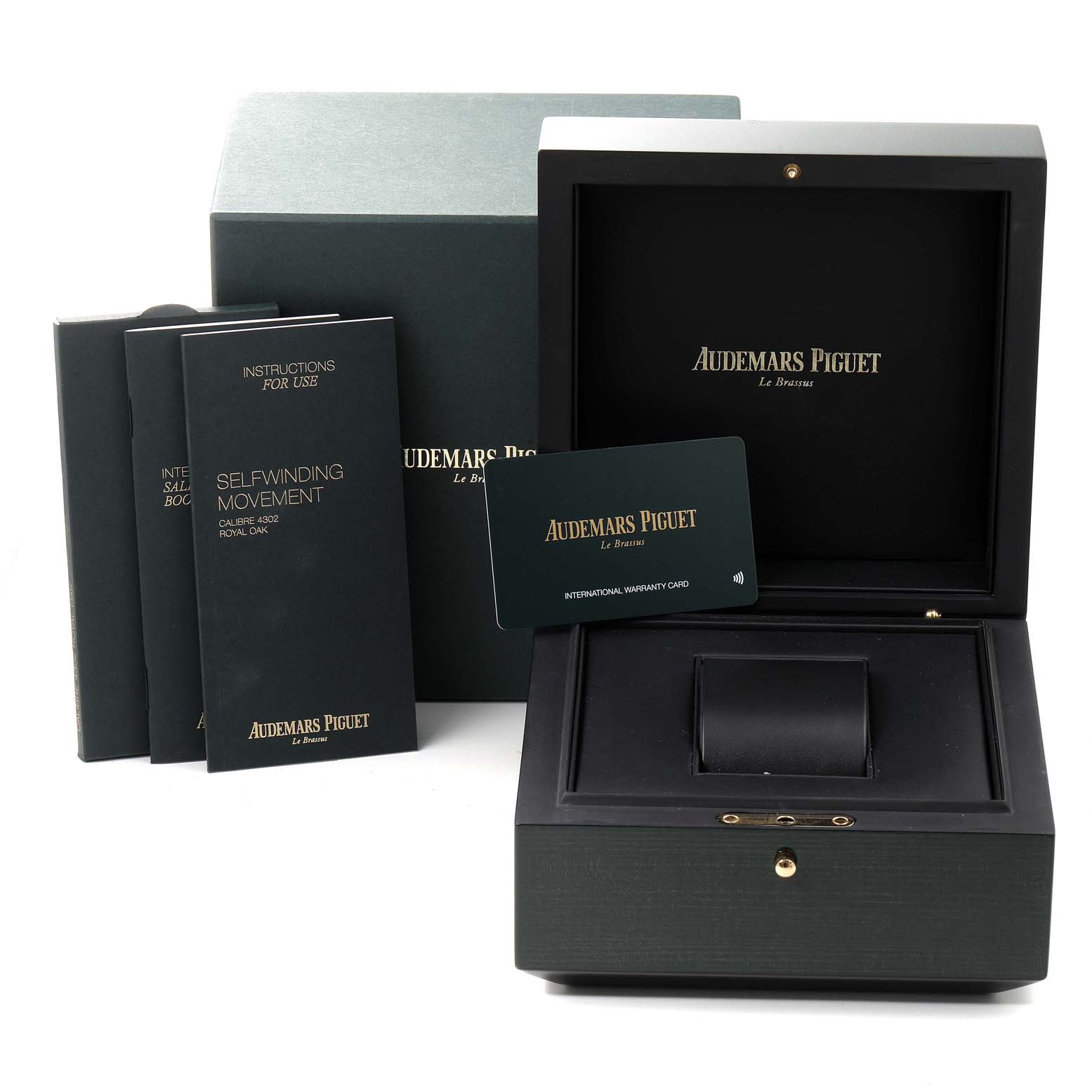 The image shows the packaging and accessories of the Audemars Piguet Royal Oak 15500ST.OO.1220ST.03 Men's Stainless Steel Black Dial 15500ST.OO.1220ST.03 Men's Stainless Steel Black Dial, including the box, manuals, and warranty card.