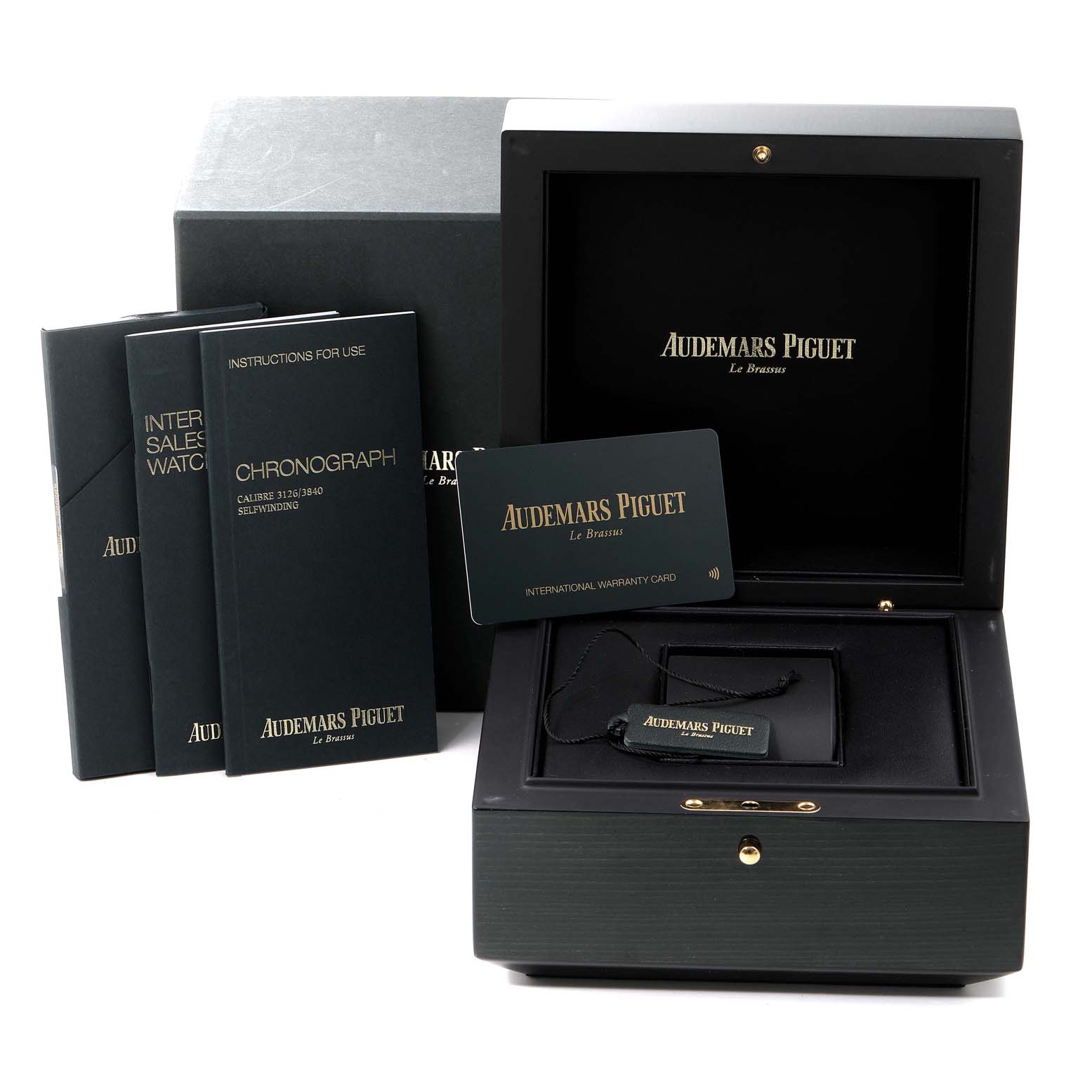 The image shows the Audemars Piguet Royal Oak Offshore 26470ST.OO.A028CR.01 Men's Stainless Steel Black Dial 26470ST.OO.A028CR.01 Men's Stainless Steel Black Dial watch accessories, including a box, manuals, and an international warranty card.