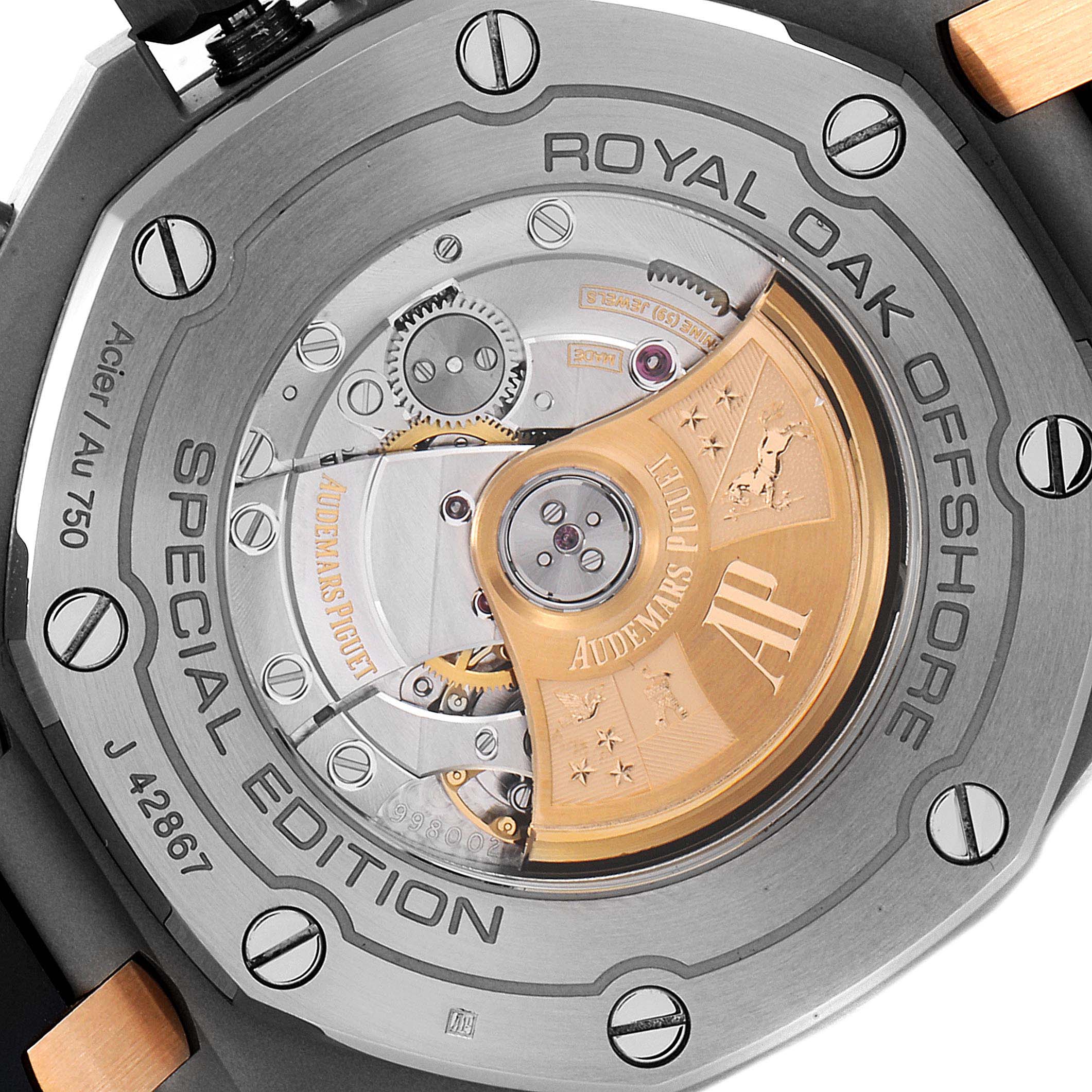 The image shows the back view of an Audemars Piguet Royal Oak Offshore 26471SR.OO.D101CR.01 Men's Steel and Gold (two tone) Blue Dial 26471SR.OO.D101CR.01 Men's Steel and Gold (two tone) Blue Dial Special Edition watch, showcasing its intricate movement and engravings.