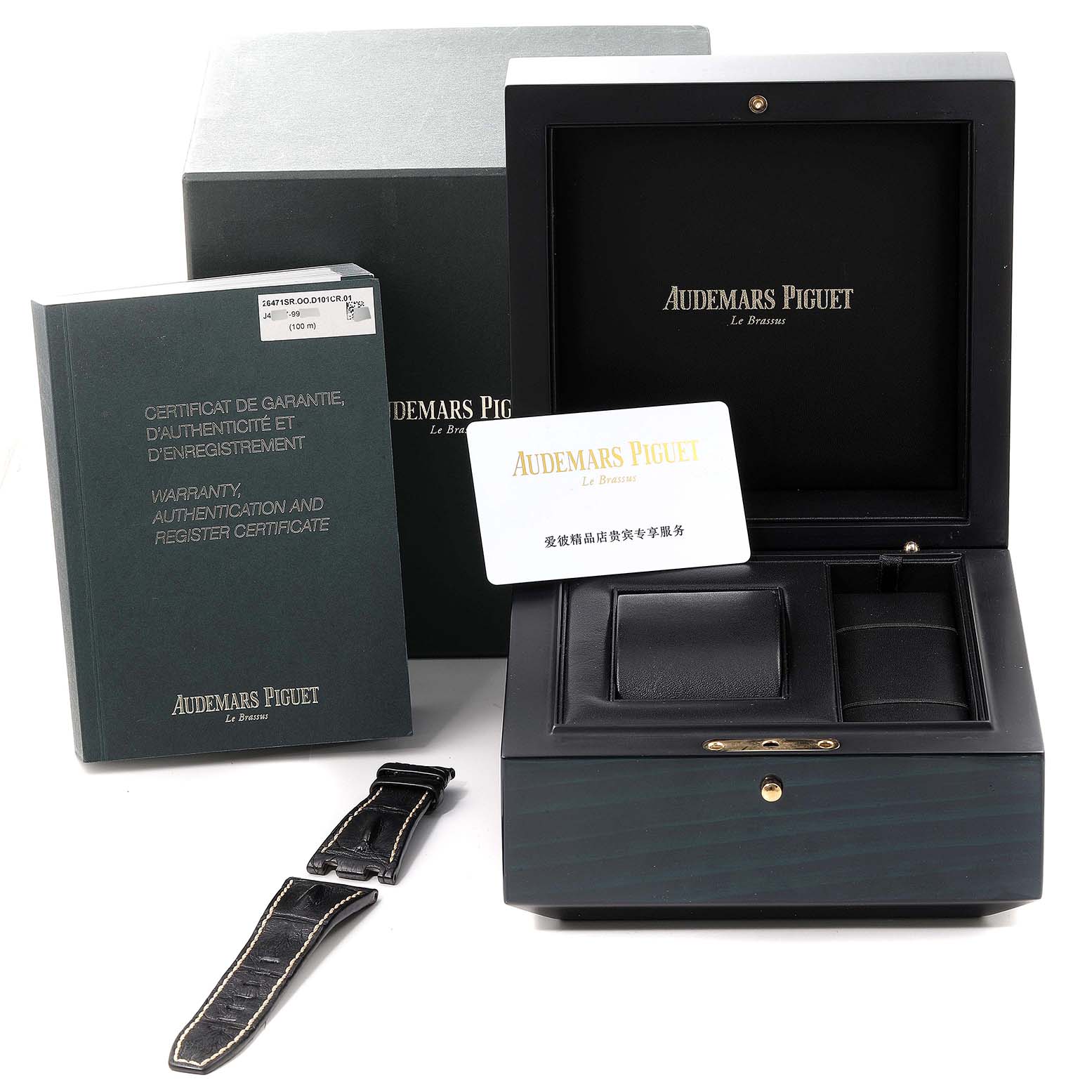 The image shows the box, warranty book, a strap, and a card for the Audemars Piguet Royal Oak Offshore 26471SR.OO.D101CR.01 Men's Steel and Gold (two tone) Blue Dial 26471SR.OO.D101CR.01 Men's Steel and Gold (two tone) Blue Dial watch.