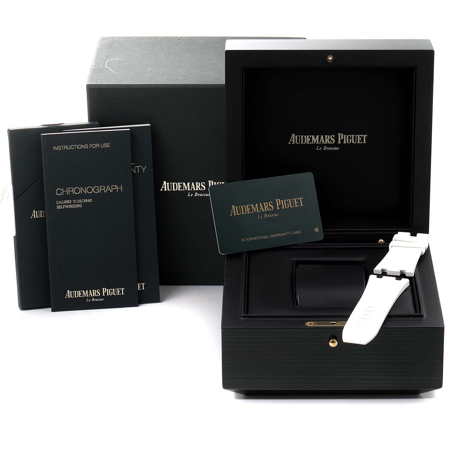 The image shows the packaging, instruction manuals, warranty card, and watch display case for the Audemars Piguet Royal Oak Offshore 26400IO.OO.A004CA.02 Men's Titanium Grey Dial 26400IO.OO.A004CA.02 Men's Titanium Grey Dial.