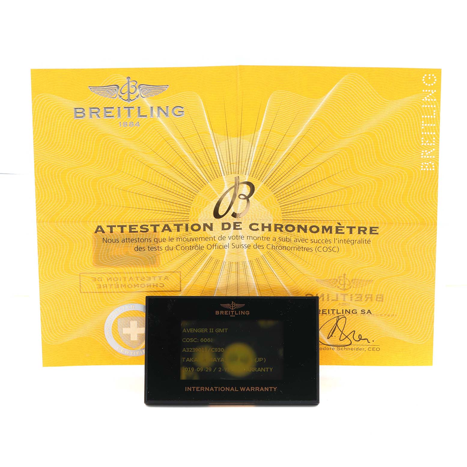 The image shows the Breitling Avenger A32390 Men's Stainless Steel Mother of Pearl Dial model's chronometer certificate and international warranty card.
