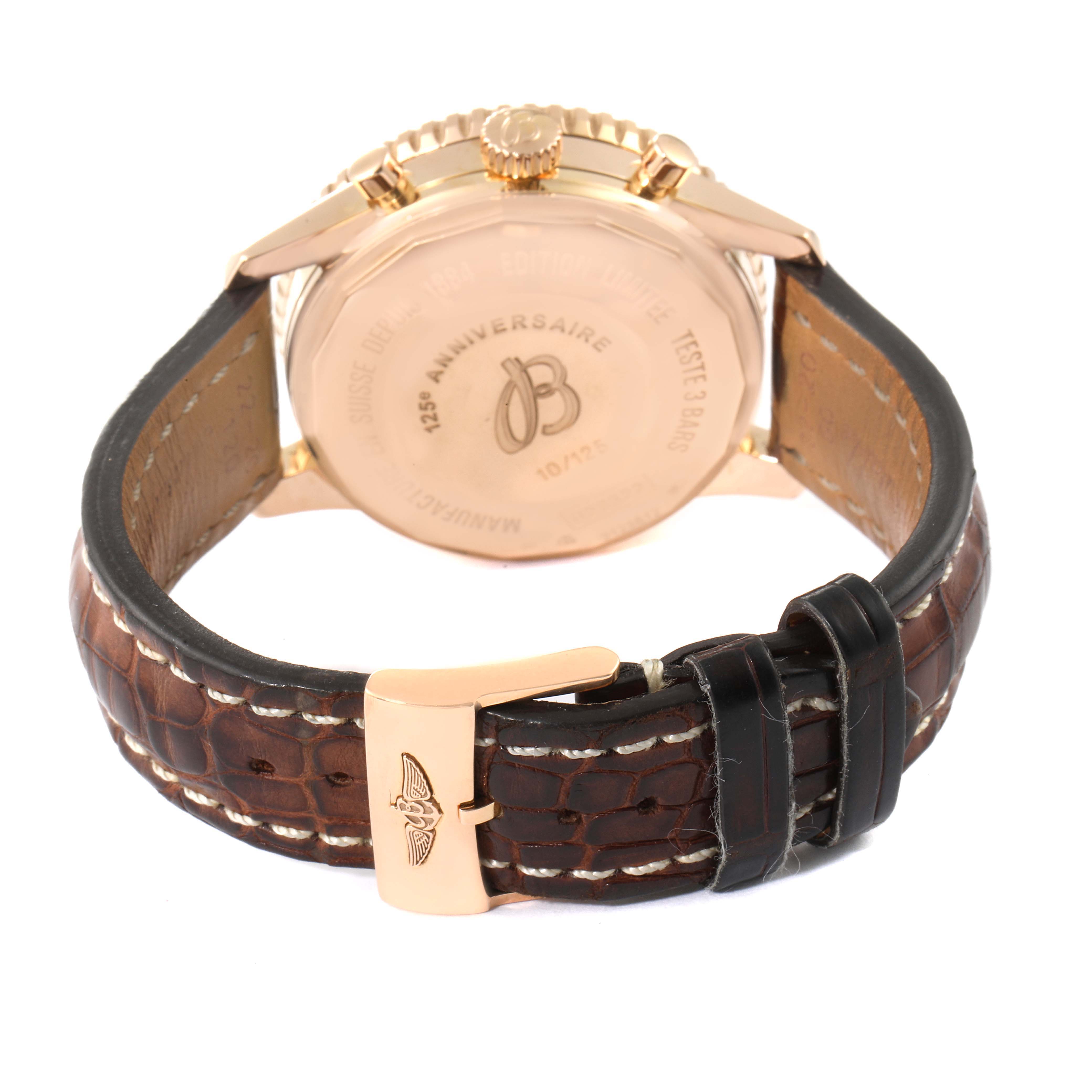 The Breitling Navitimer R26322 Men's Rose Gold Silver Dial R26322 Men's Rose Gold Silver Dial watch is shown from the back, highlighting its case back, crown, and brown leather strap with a buckle.