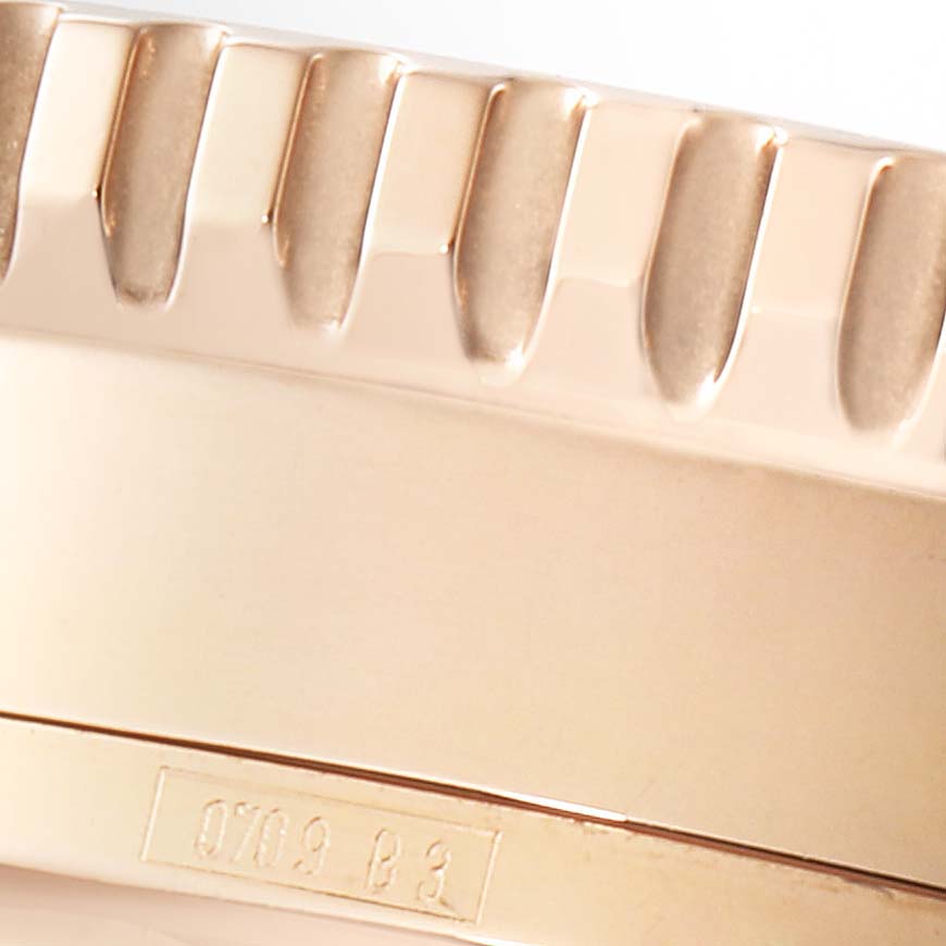 This close-up image shows the side of the bezel of the Breitling Navitimer R26322 Men's Rose Gold Silver Dial R26322 Men's Rose Gold Silver Dial watch.