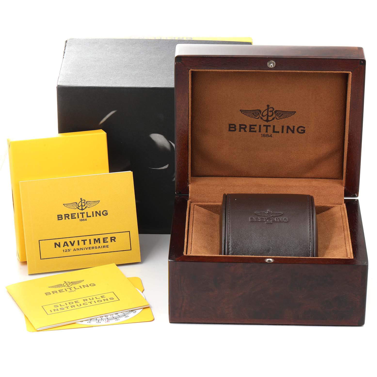 The image shows a Breitling Navitimer R26322 Men's Rose Gold Silver Dial R26322 Men's Rose Gold Silver Dial watch box, leather case, and instruction booklets from an angle displaying the open box.