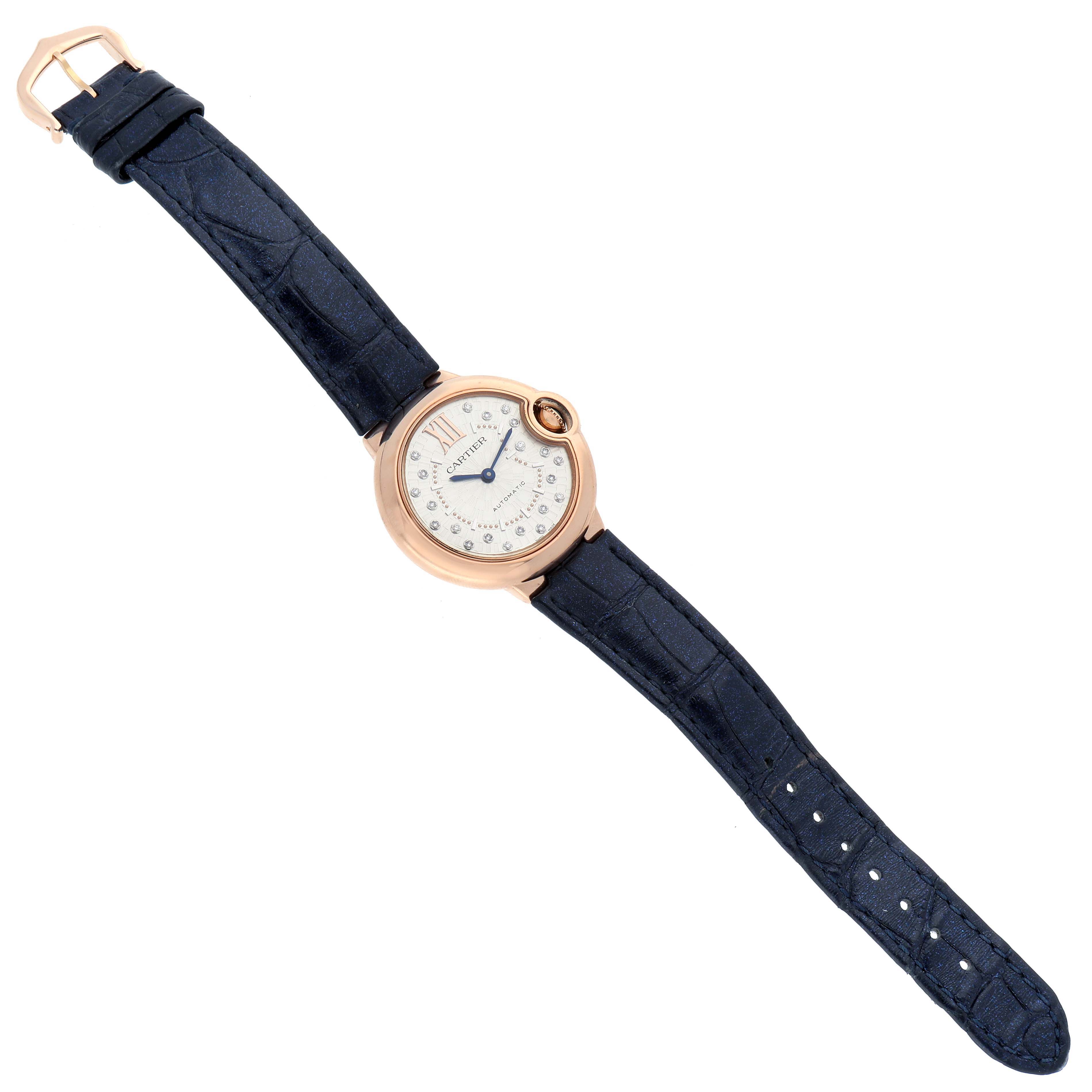 The Cartier Ballon Bleu WGBB0053 Women
s Rose Gold Silver Dial watch is shown from a top-down angle, displaying its face, strap, and buckle.