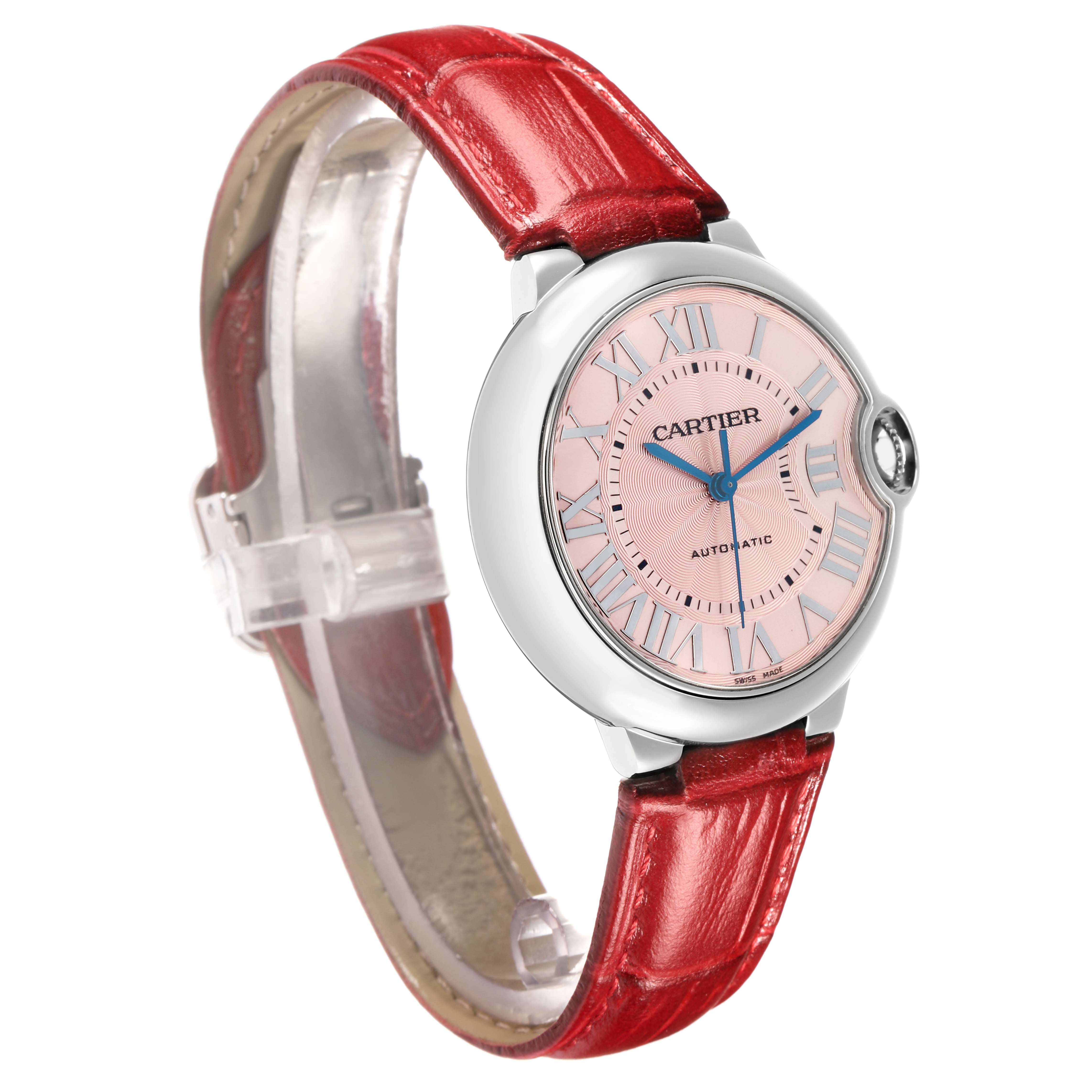 The Cartier Ballon Bleu WSBB0007 Women
s Stainless Steel Pink Dial watch is shown at an angle displaying the face, crown, and red leather strap.