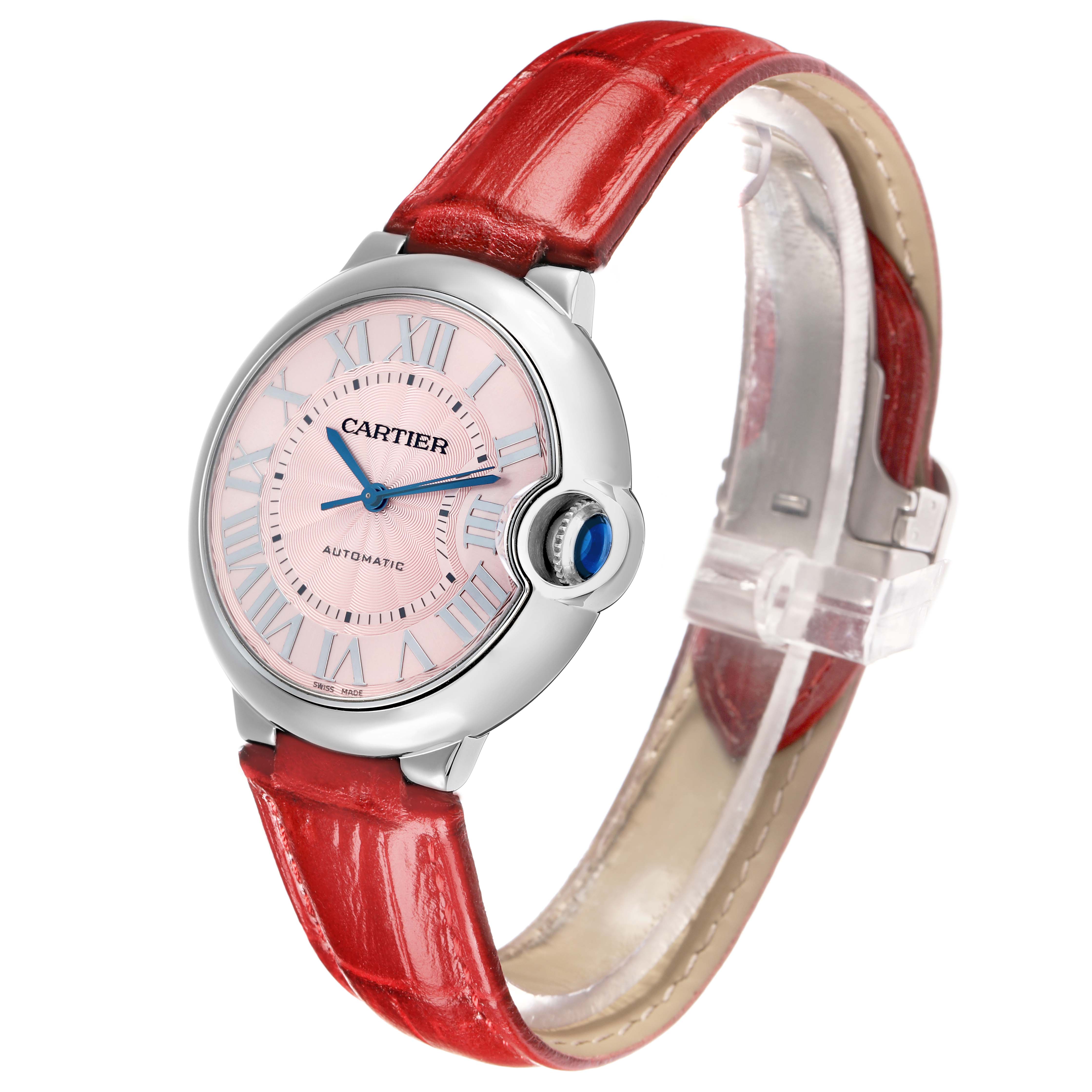 The Cartier Ballon Bleu WSBB0007 Women
s Stainless Steel Pink Dial watch is shown at an angled side view, displaying its face and red leather strap.
