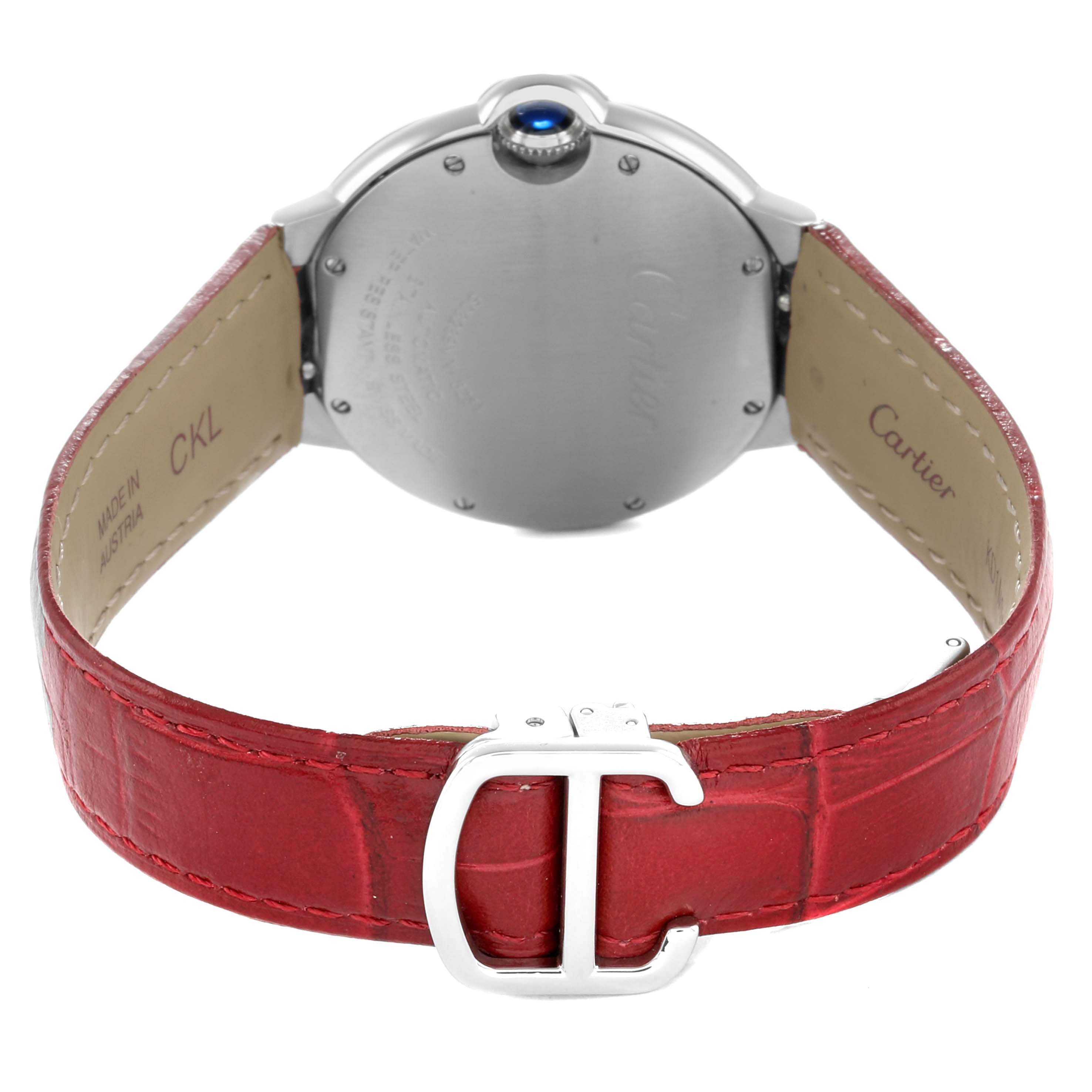 The image shows the back of a Cartier Ballon Bleu WSBB0007 Women
s Stainless Steel Pink Dial watch with a red strap and visible crown, showcasing the leather strap and buckle.