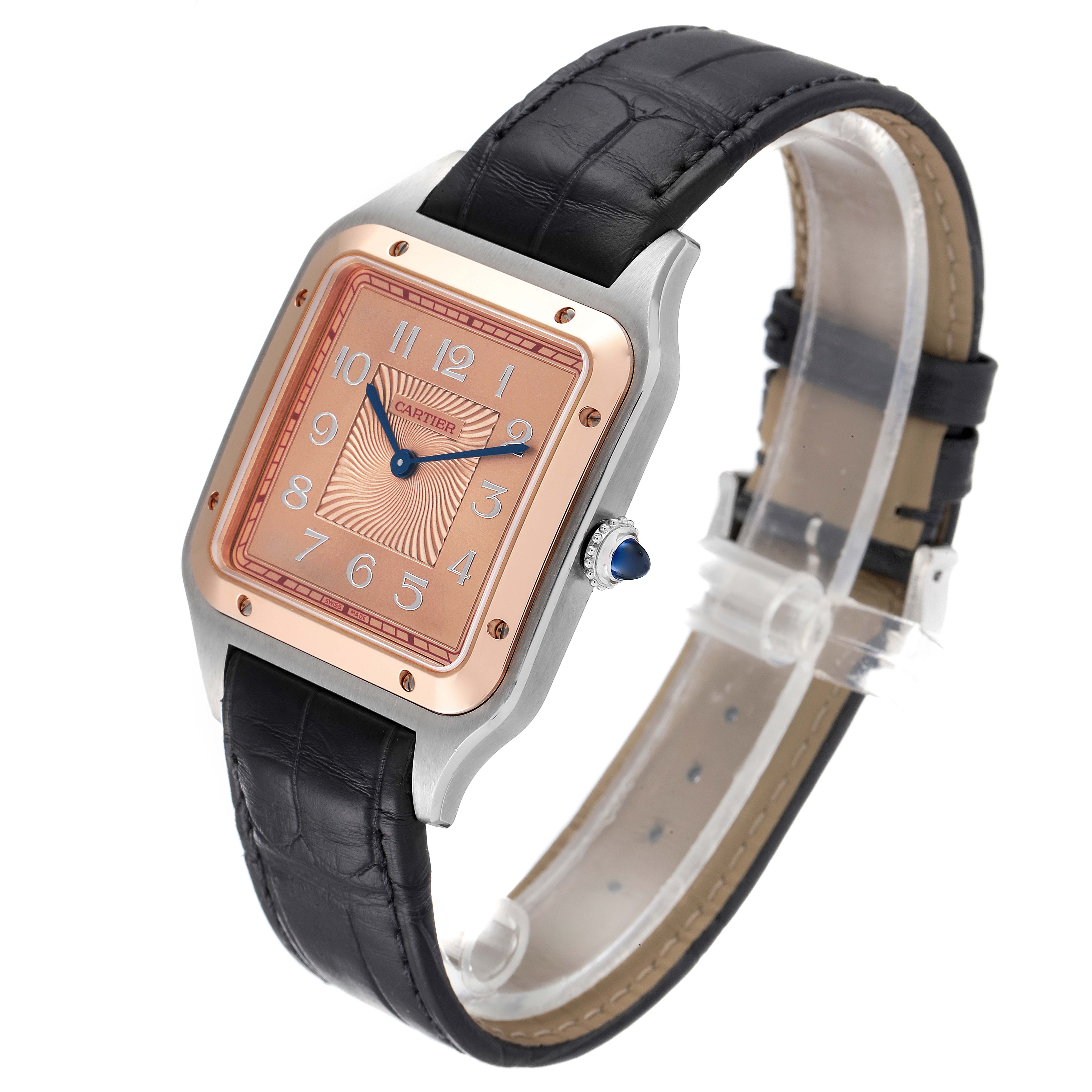 This image shows a Cartier Santos W2SA0025 Men's Steel and Gold (two tone) Pink Dial W2SA0025 Men's Steel and Gold (two tone) Pink Dial watch at a three-quarter angle, highlighting its black strap, square bezel, and rose gold dial.