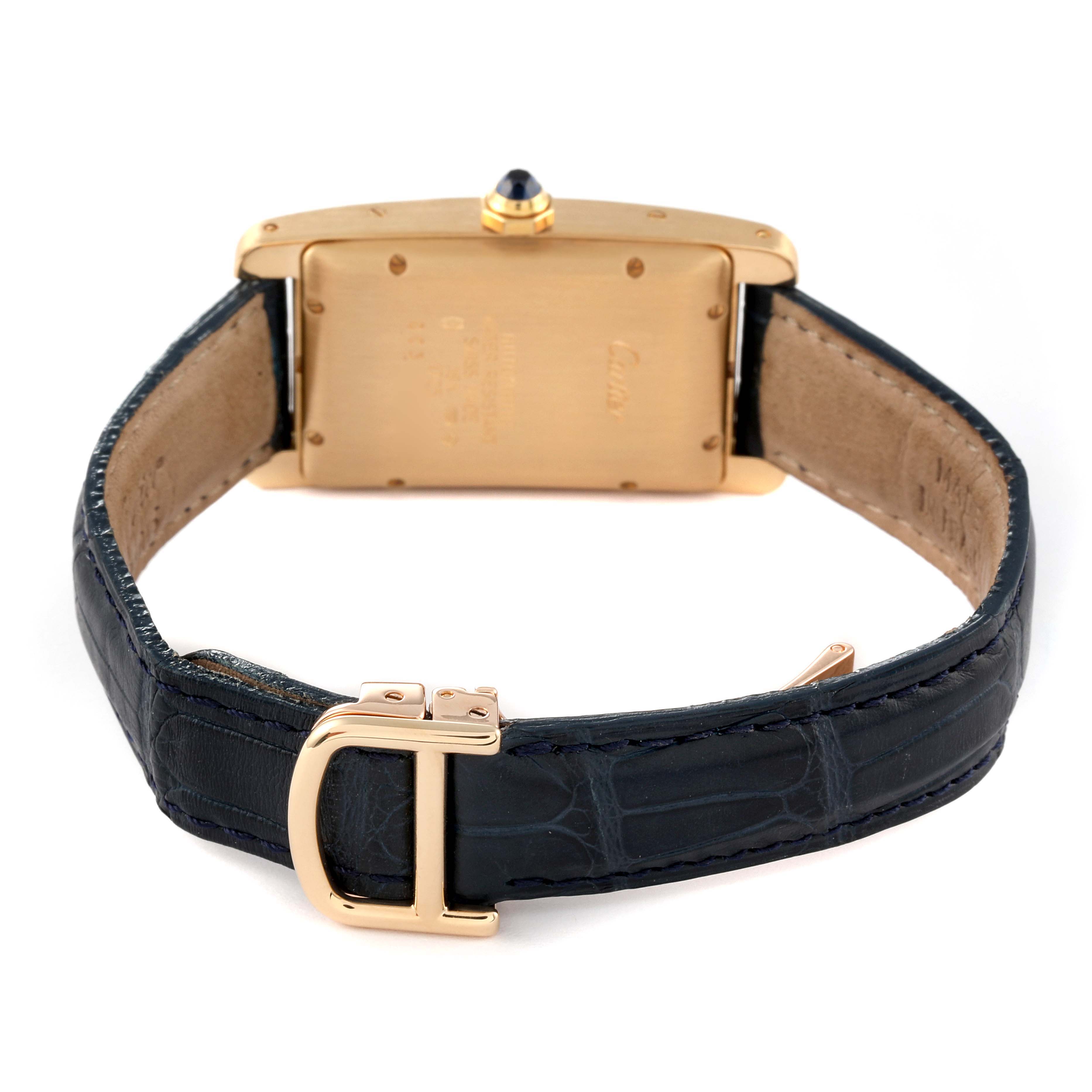 The image shows the back view of a Cartier Tank Americaine W2603556 Men
s Yellow Gold Silver Dial W2603556 Men
s Yellow Gold Silver Dial watch, highlighting the case, strap, buckle, and crown with a blue cabochon.