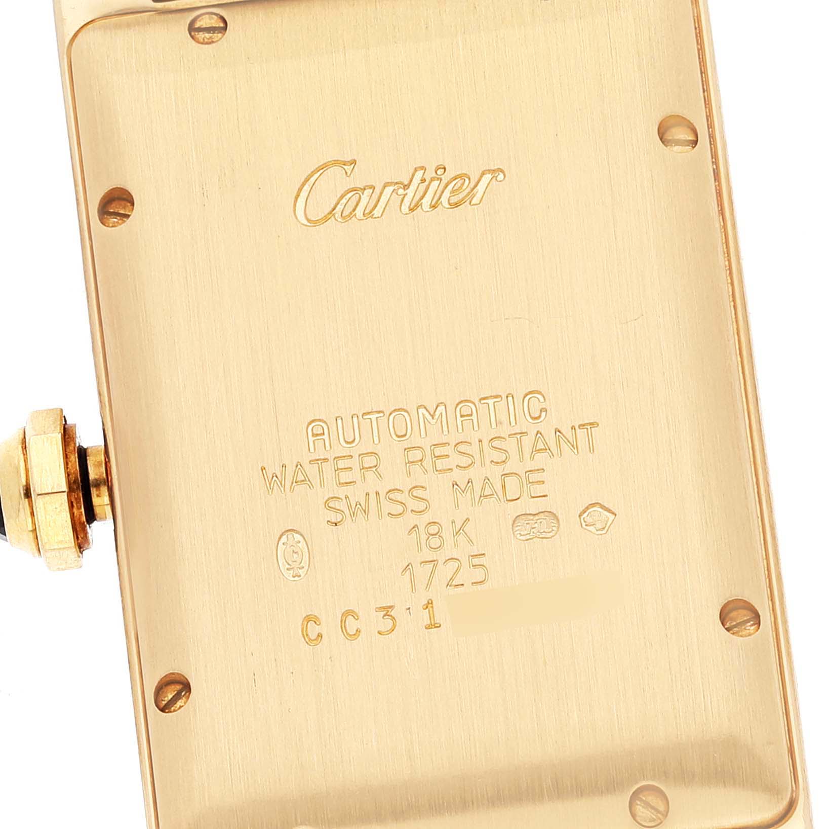 The image shows the case back of a Cartier Tank Americaine W2603556 Men
s Yellow Gold Silver Dial W2603556 Men
s Yellow Gold Silver Dial watch, displaying engravings and the crown on the left.