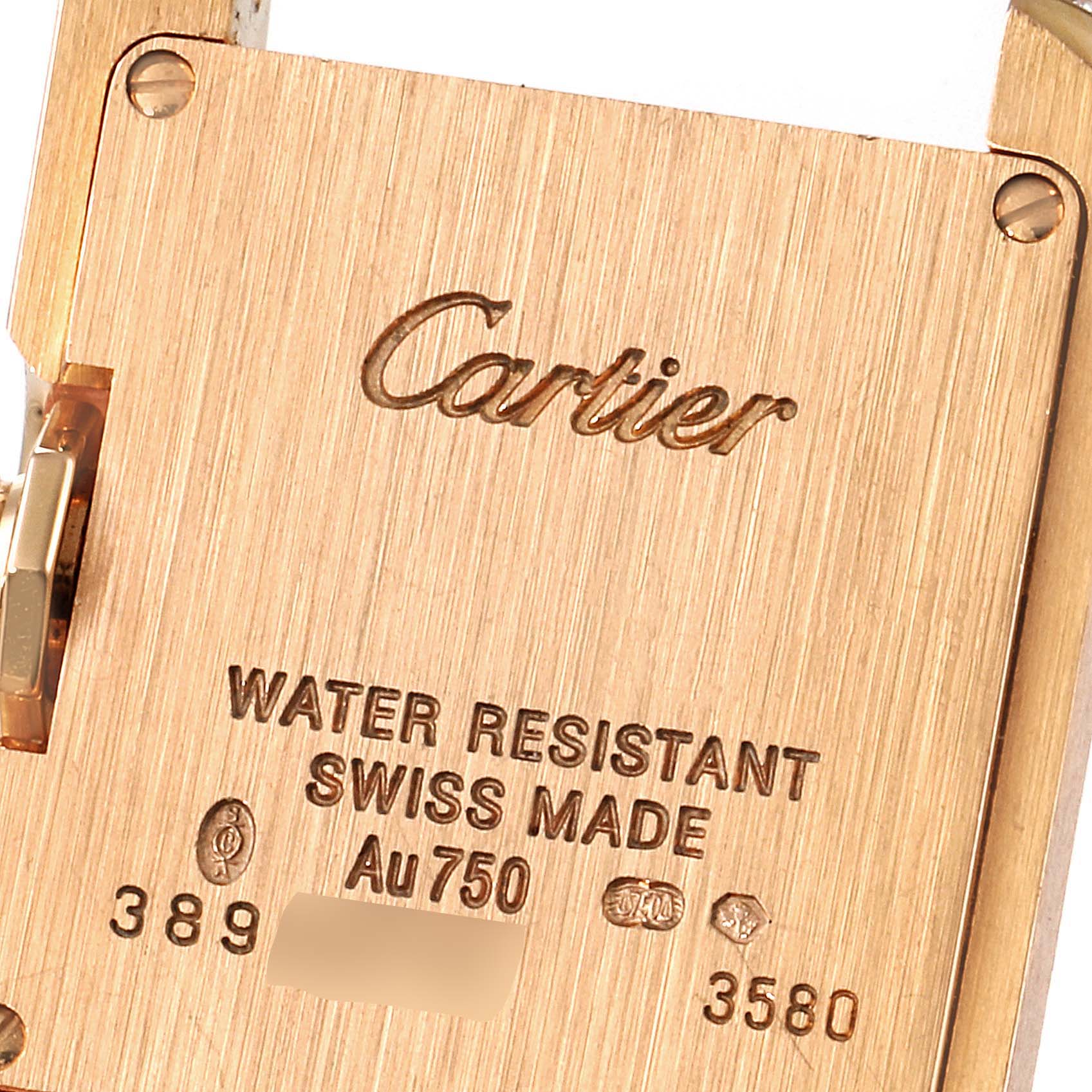 This image shows the back of a Cartier Tank Anglaise WT100013 Women's Rose Gold Silver Dial WT100013 Women's Rose Gold Silver Dial watch, displaying its engravings and markings.