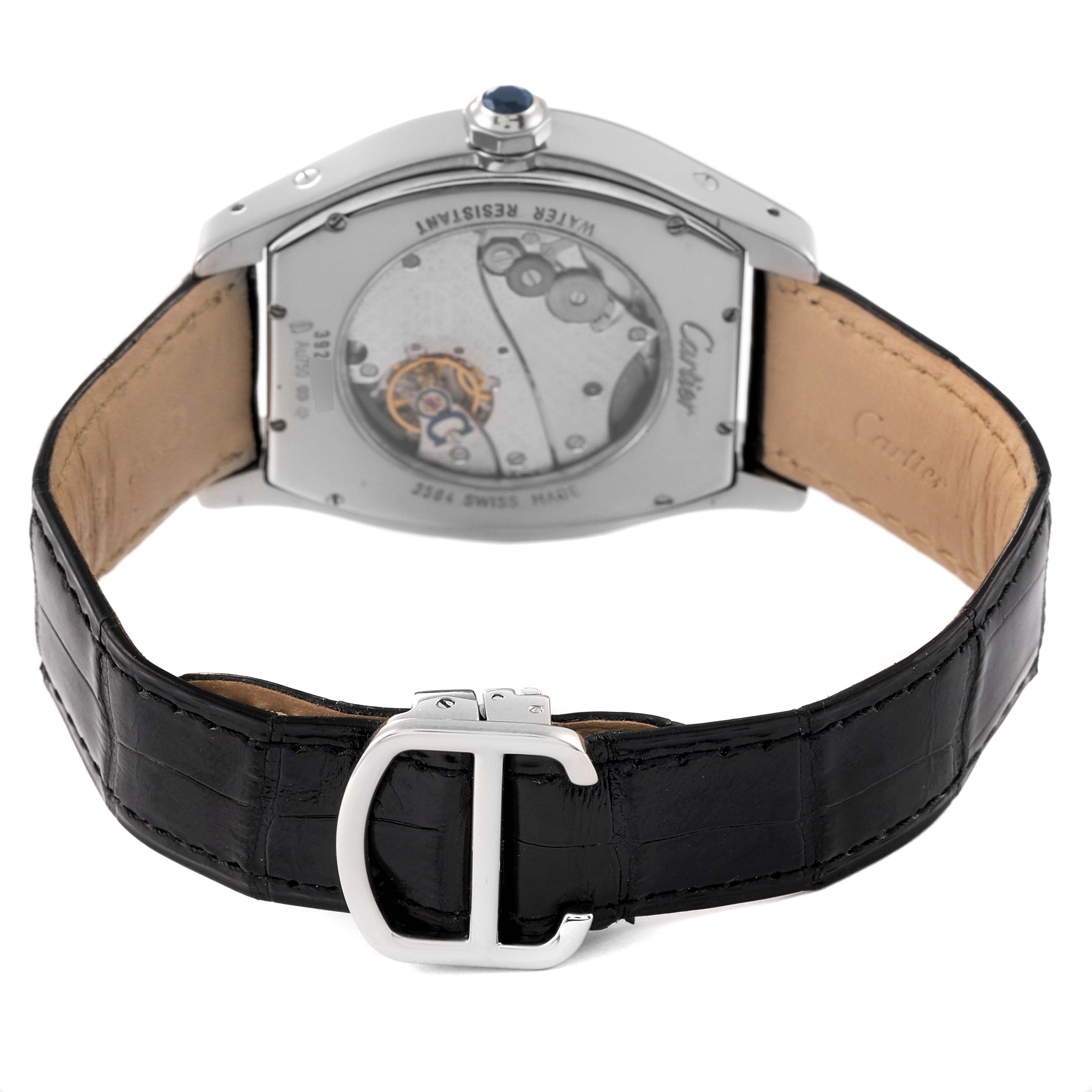 The image shows the back view of the Cartier Tortue W1556233 Men's White Gold Silver Dial W1556233 Men's White Gold Silver Dial watch, highlighting its movement and black leather strap with a clasp.
